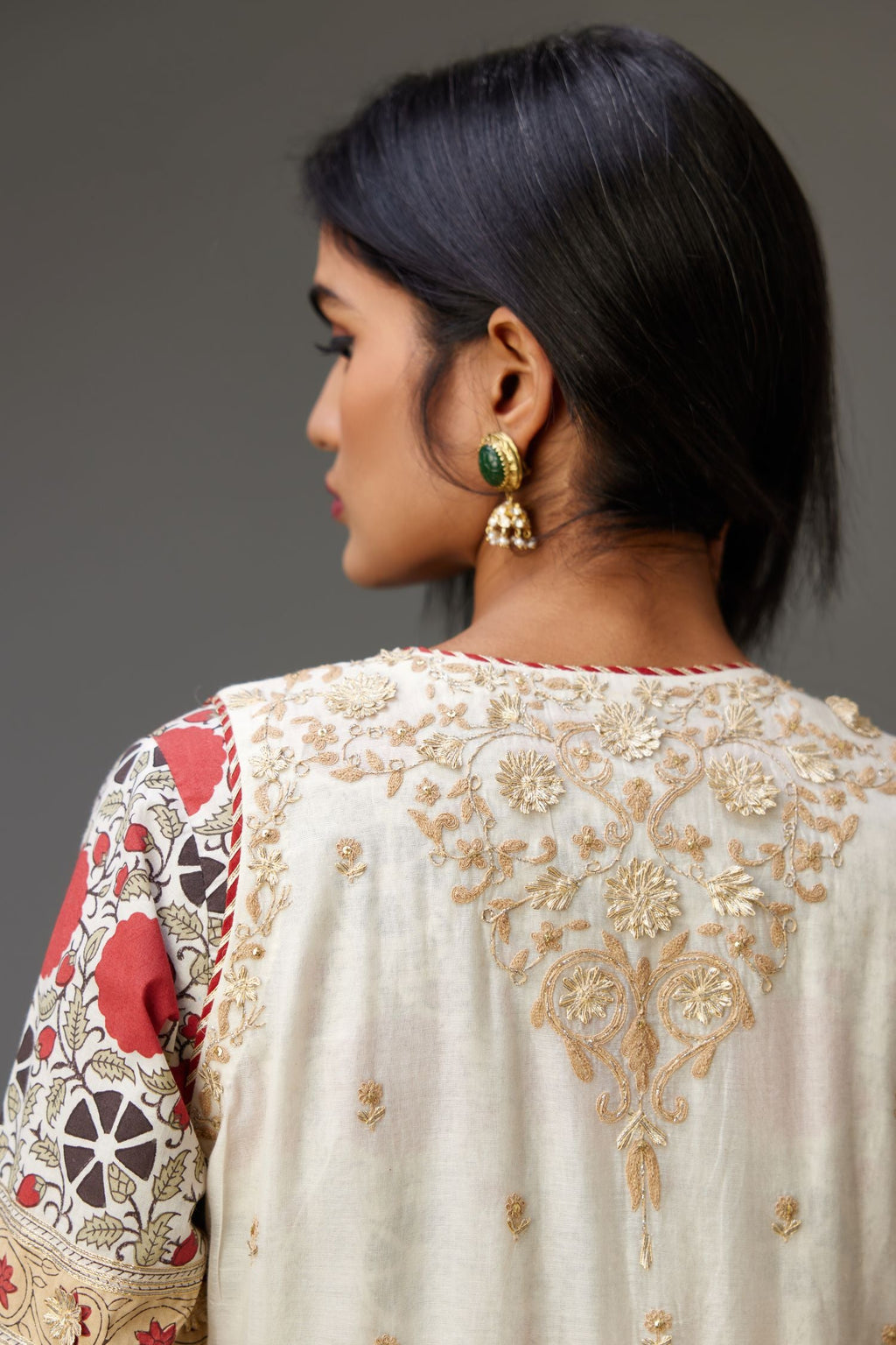 Off white cotton chanderi front open sleeveless jacket set with dori and gota embroidery detailing, highlighted with gold sequin work.
