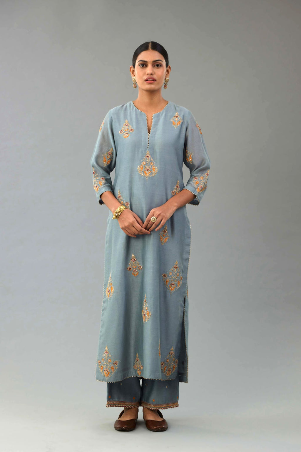 Light blue silk chanderi straight kurta set with zari, dori and contrast silk thread embroidered bootas, highlighted with gold sequins work.
