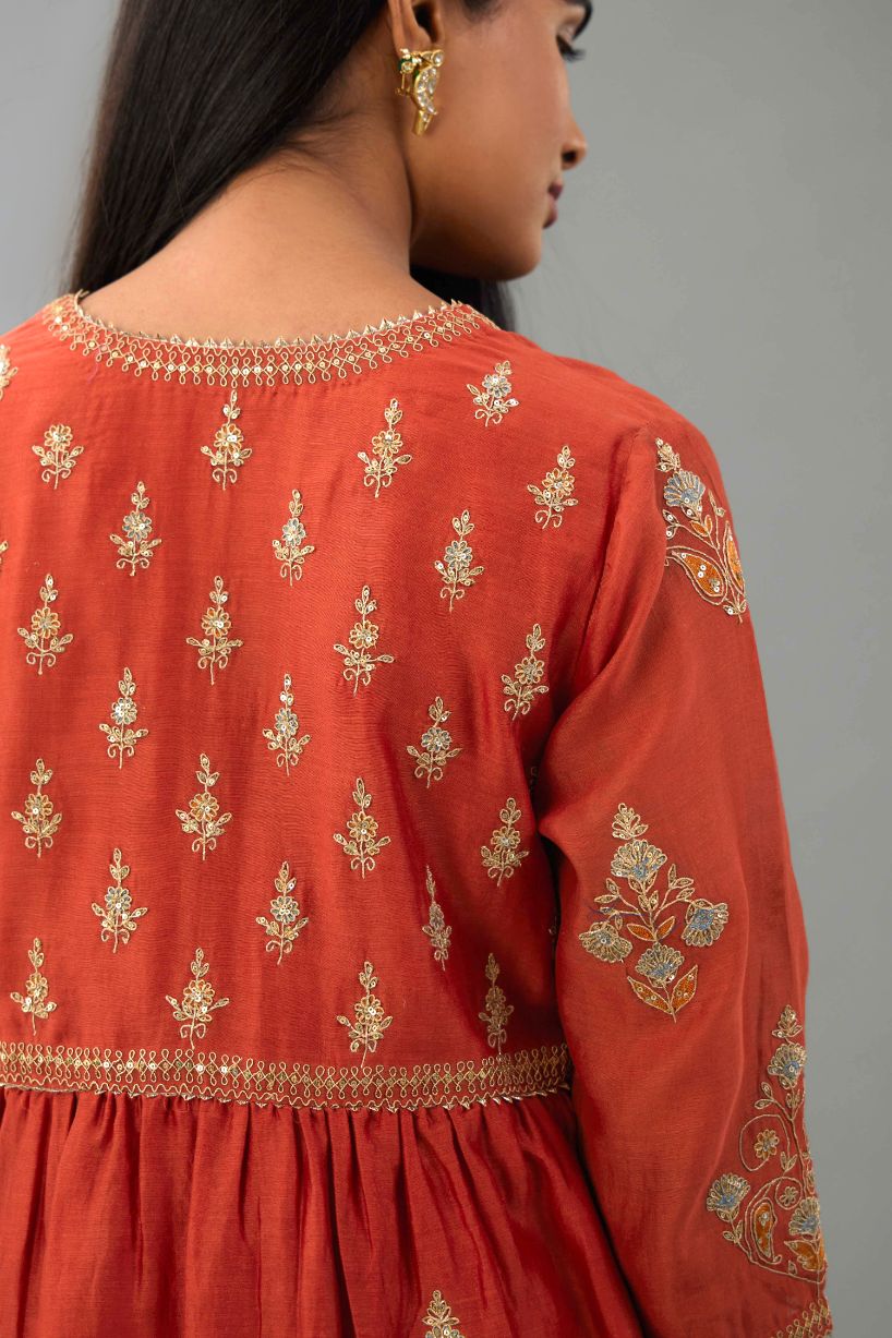 Rust silk chanderi kurta-dress set with all-over zari, dori and contrast silk thread embroidery, highlighted with gold sequins work.