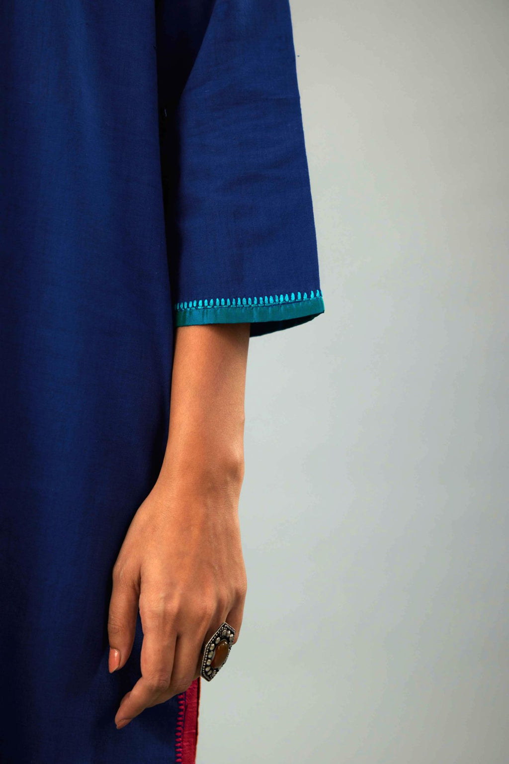 Blue handloom cotton straight kurta set with multi colored silk facings and embroidery detail.