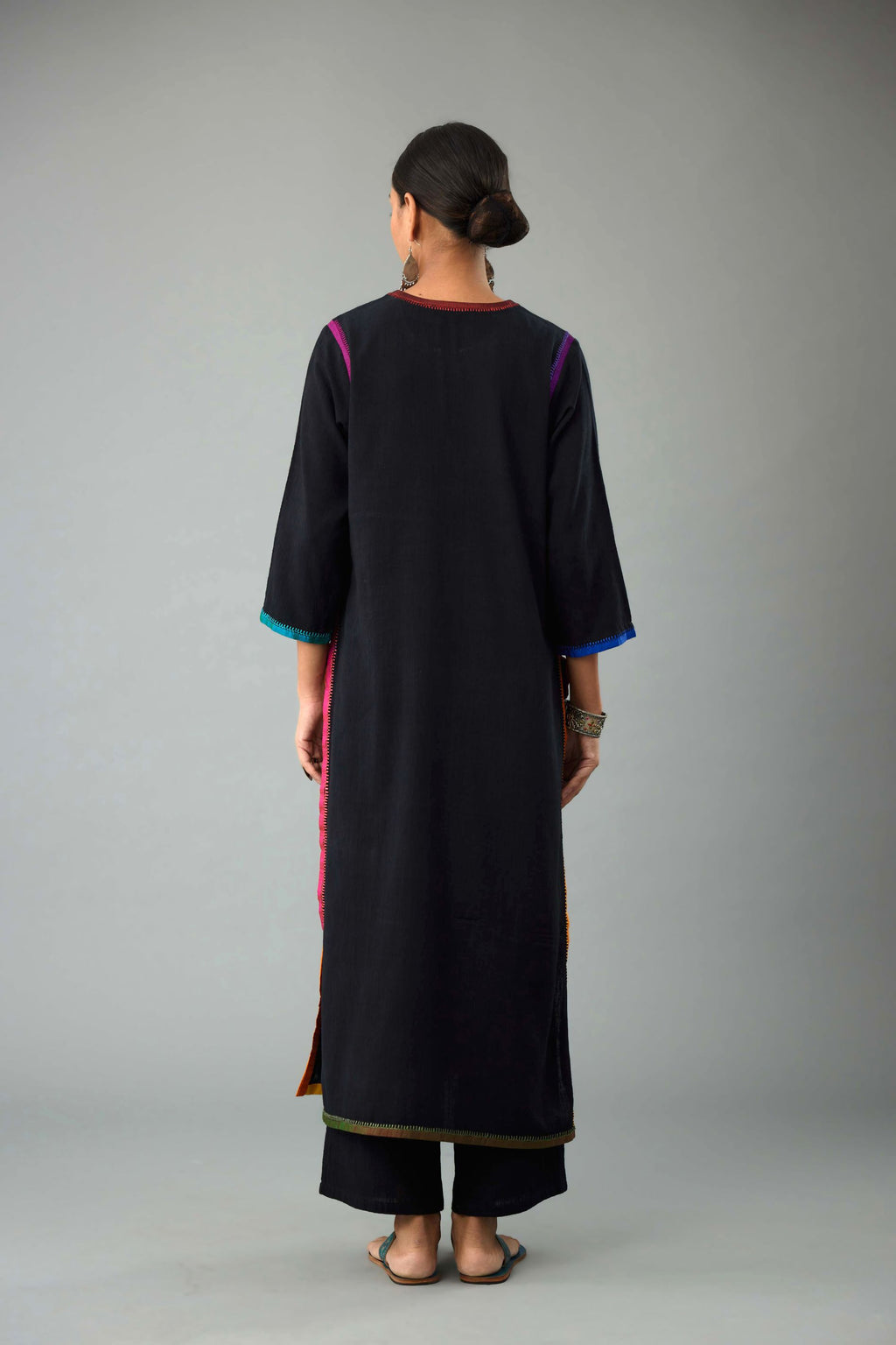 Black handloom cotton straight kurta with slit neck, multi colored silk facings and embroidery detail.