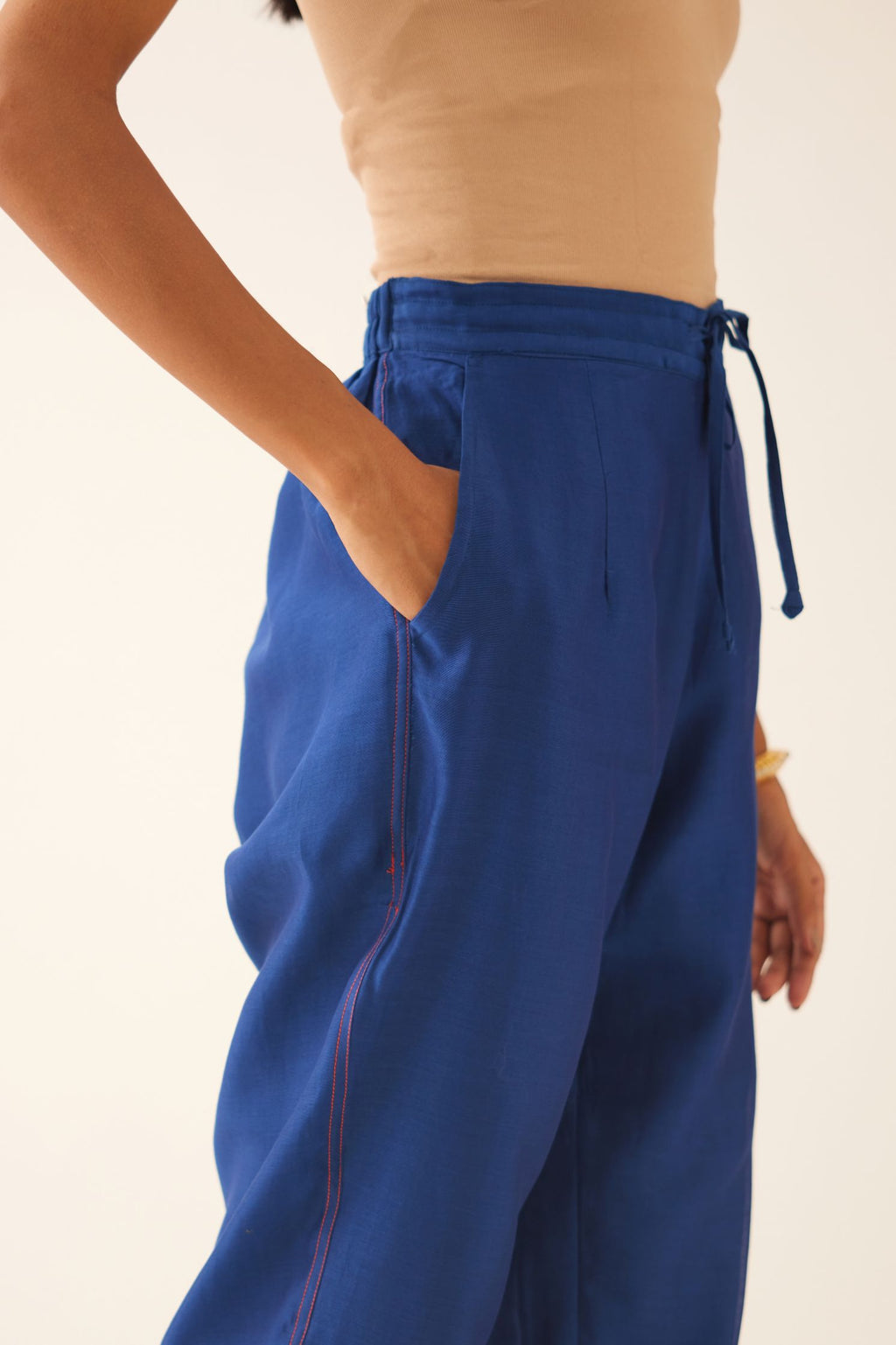 Blue silk chanderi straight pants with quilted embroidery at hem.