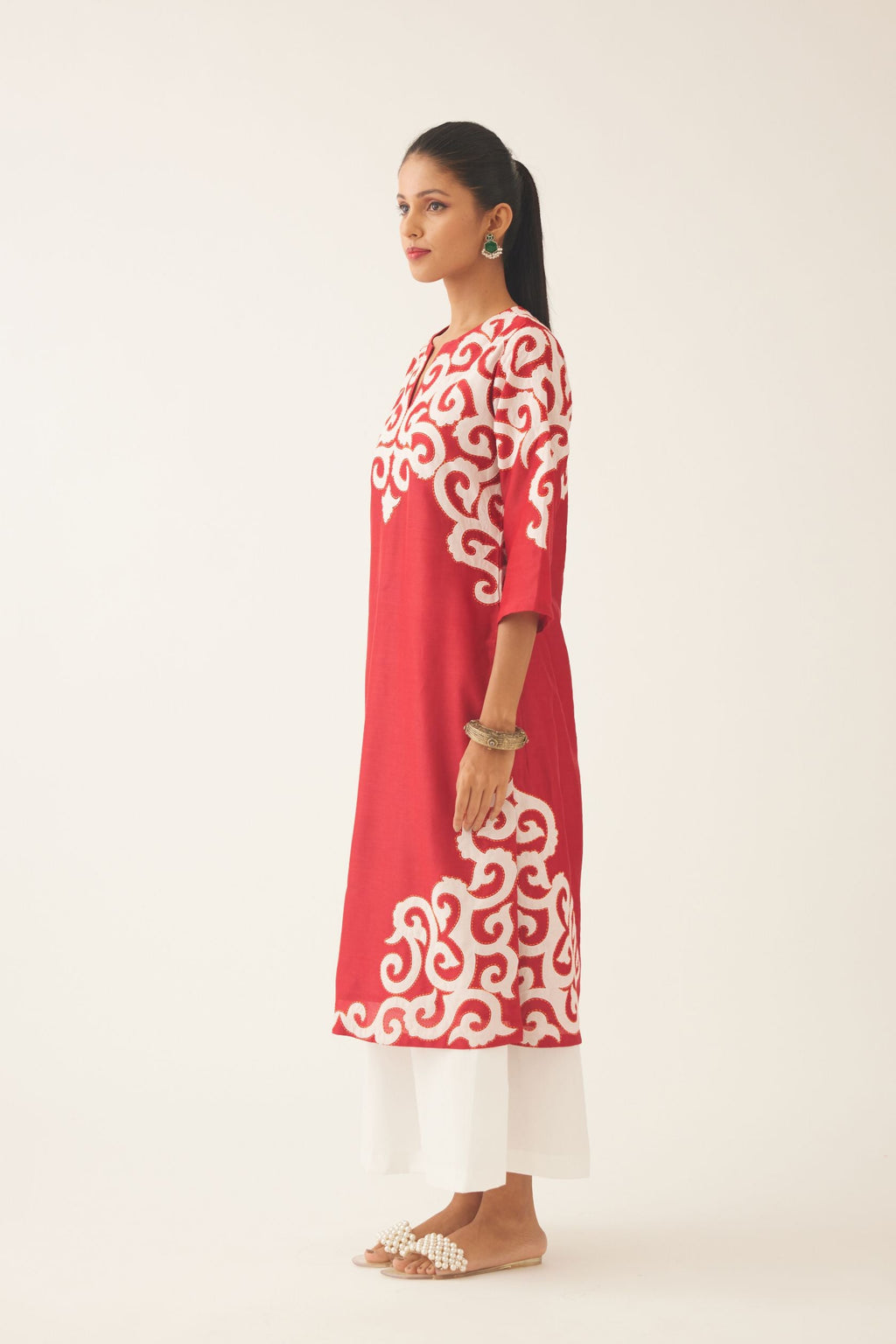Red straight kurta with cotton appliqué, highlighted with kantha work, paired with off white cotton wide leg pants with side pockets.