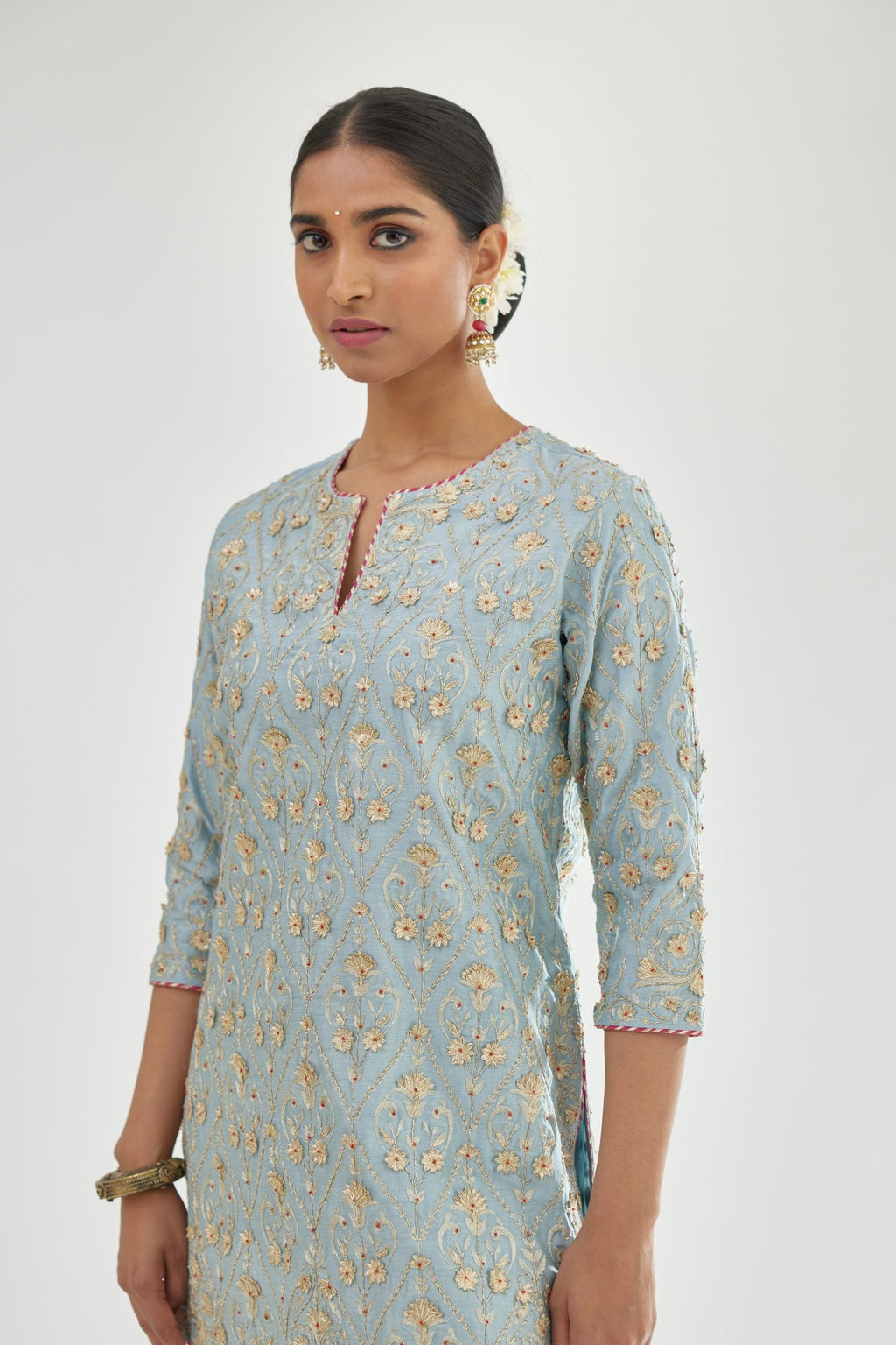 Blue short kurta set detailed with all-over zari, dori, sequins and gota embroidery.