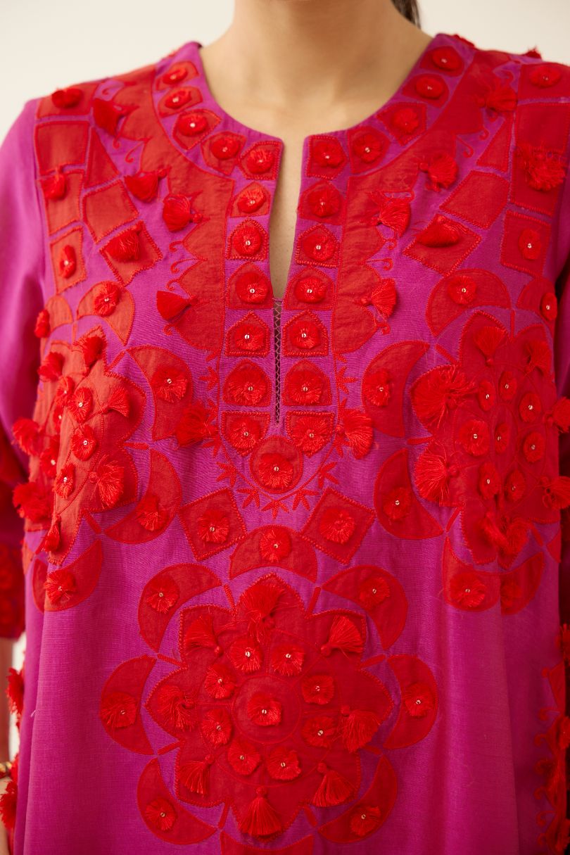 Fuchsia silk chanderi A-line kurta set, highlighted with contrast applique, tassels and sequins.