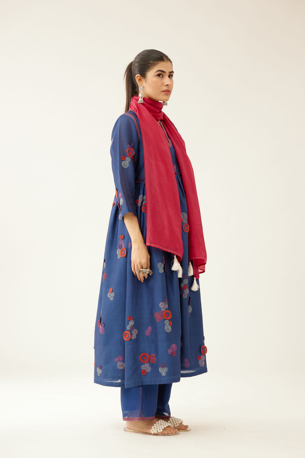 Blue silk chanderi long kurta set, highlighted with all-over multi colored 3D spiral embroidery and contrast over lock detail at empire waist.