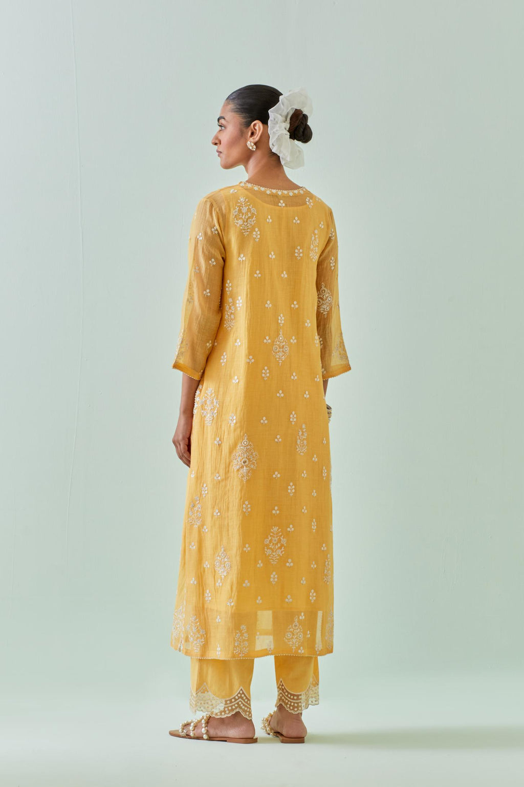 Yellow straight kurta set with all-over off white Dori embroidery and highlighted with delicate beaded work.