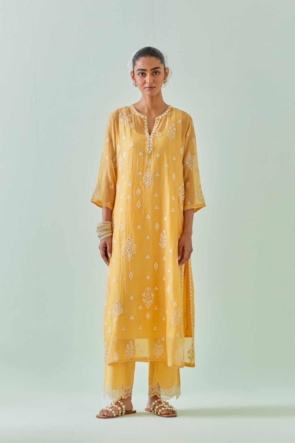 Yellow straight kurta set with all-over off white Dori embroidery and highlighted with delicate beaded work.
