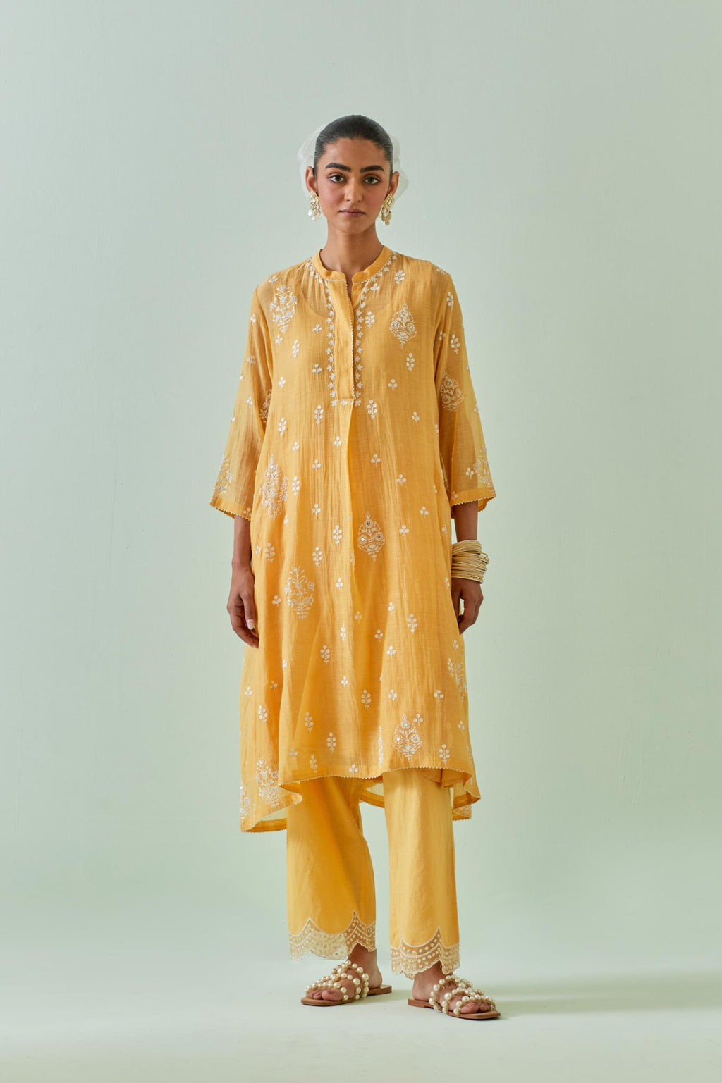 Yellow short shirt-kurta set with all-over off white Dori embroidery and highlighted with delicate beaded work.