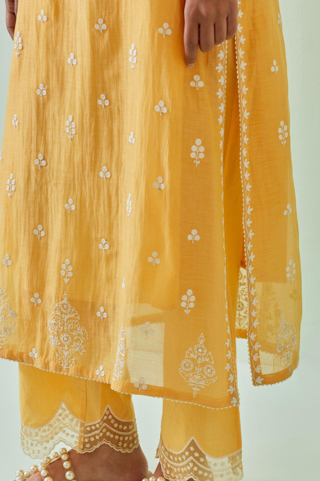 Yellow straight kurta set with all-over off white Dori embroidery and highlighted with delicate beaded hand work.