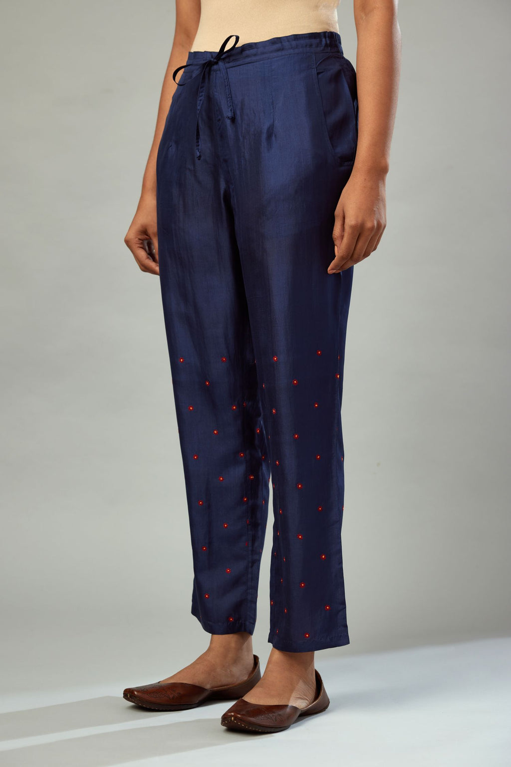 Indigo silk straight pants detailed with small flower embroidery at bottom.