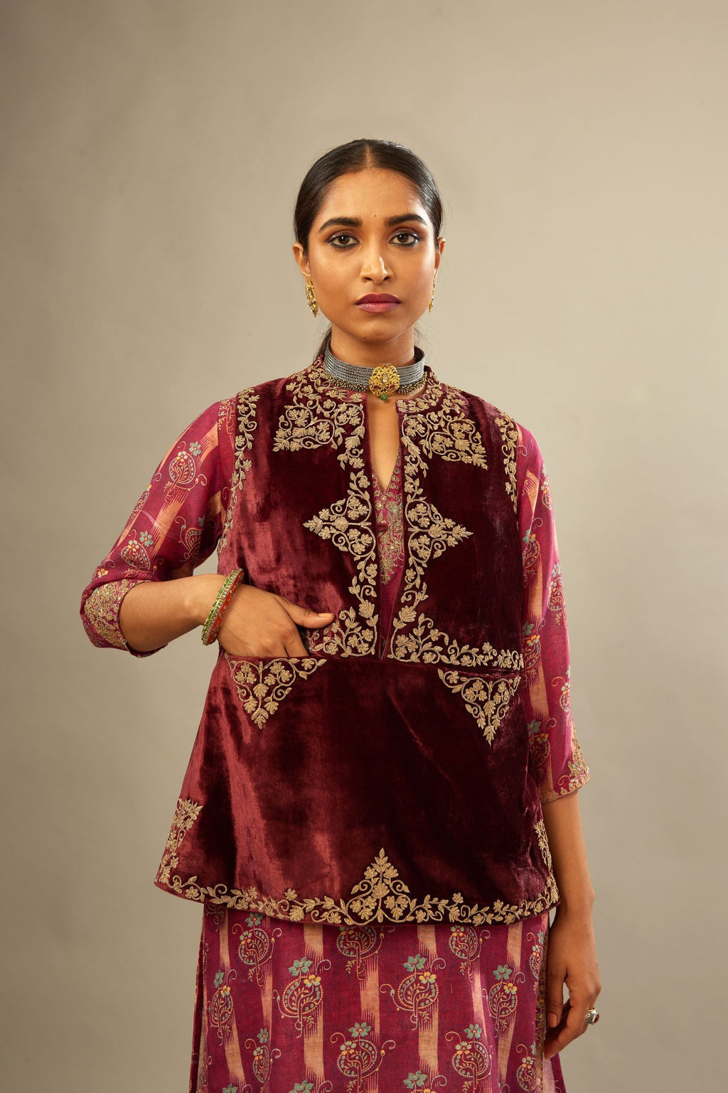 Maroon easy fit, short, sleeveless, silk-velvet jacket, embellished with antique gold embroidery.