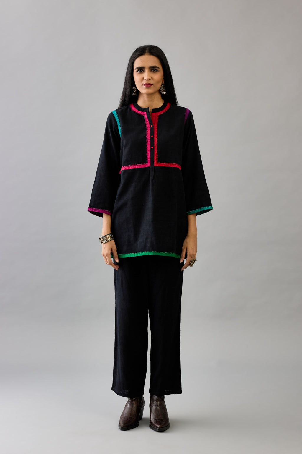 Black handloom cotton short top with multi colored silk facings and embroidery detail, paired with black handloom cotton straight pants.