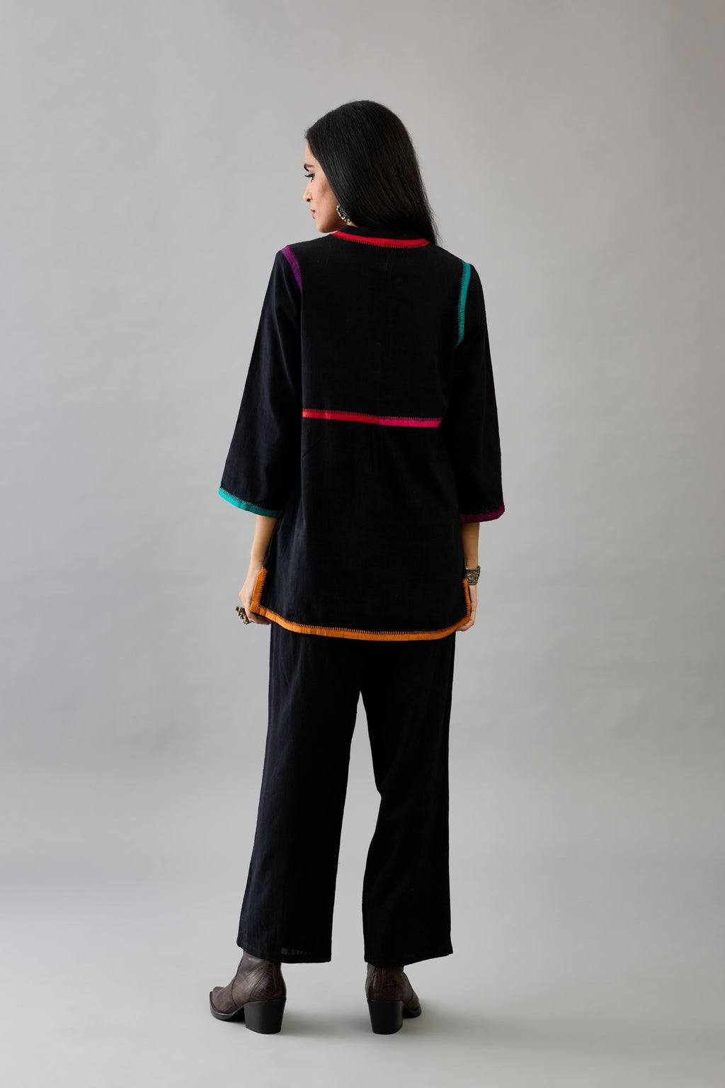 Black handloom cotton short top with multi colored silk facings and embroidery detail, paired with black handloom cotton straight pants.