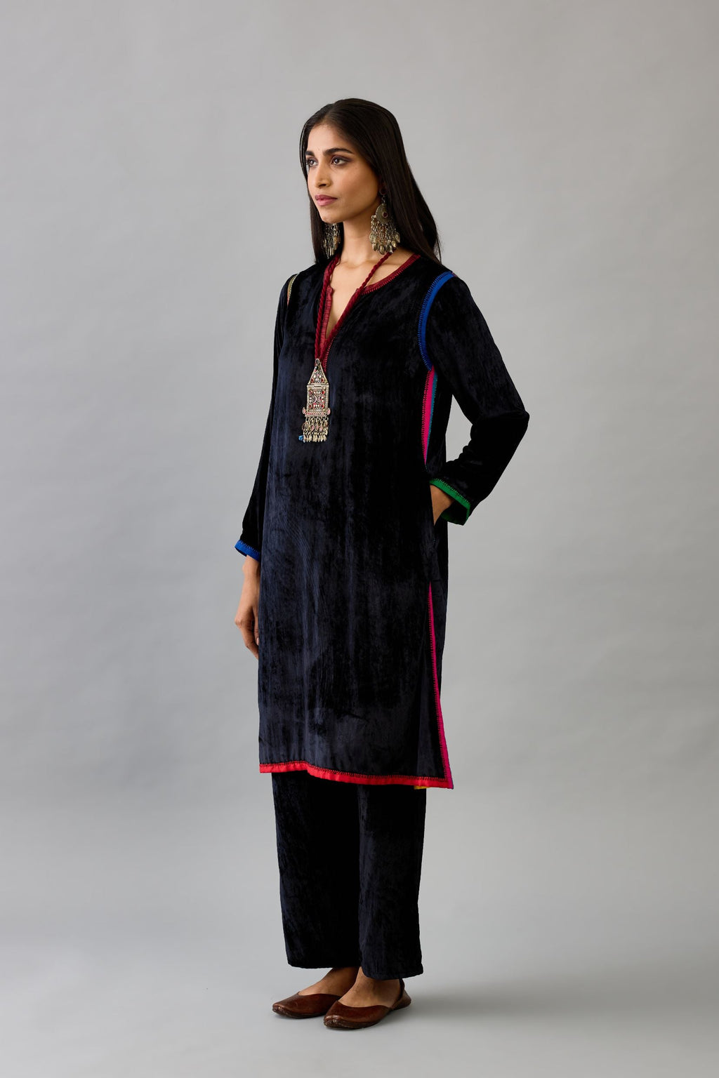 Black silk velvet short A-line kurta with multi colored silk facing and embroidery.