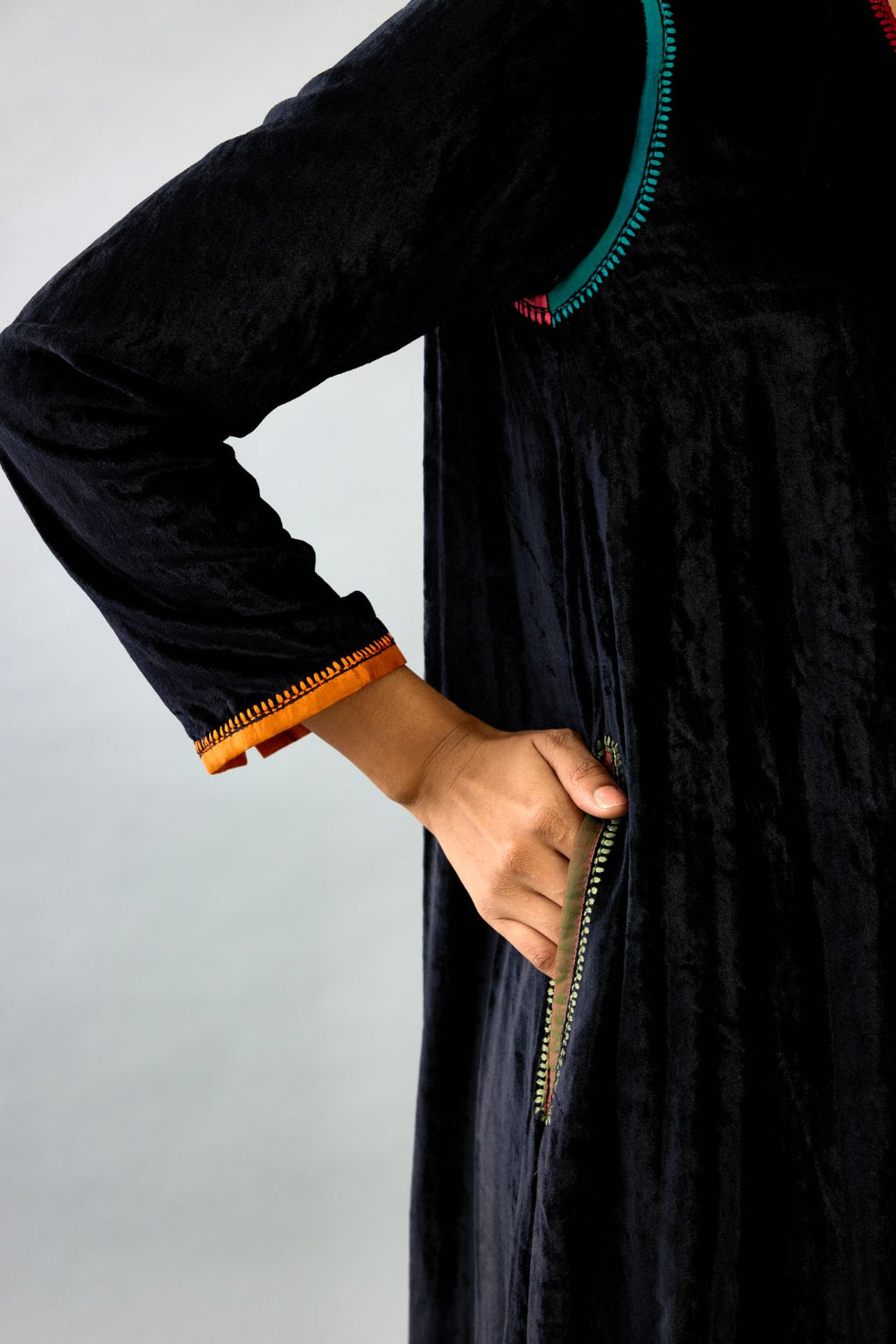 Black silk velvet long A-line kurta with multi colored silk facing and embroidery, paired with black silk velvet straight pants