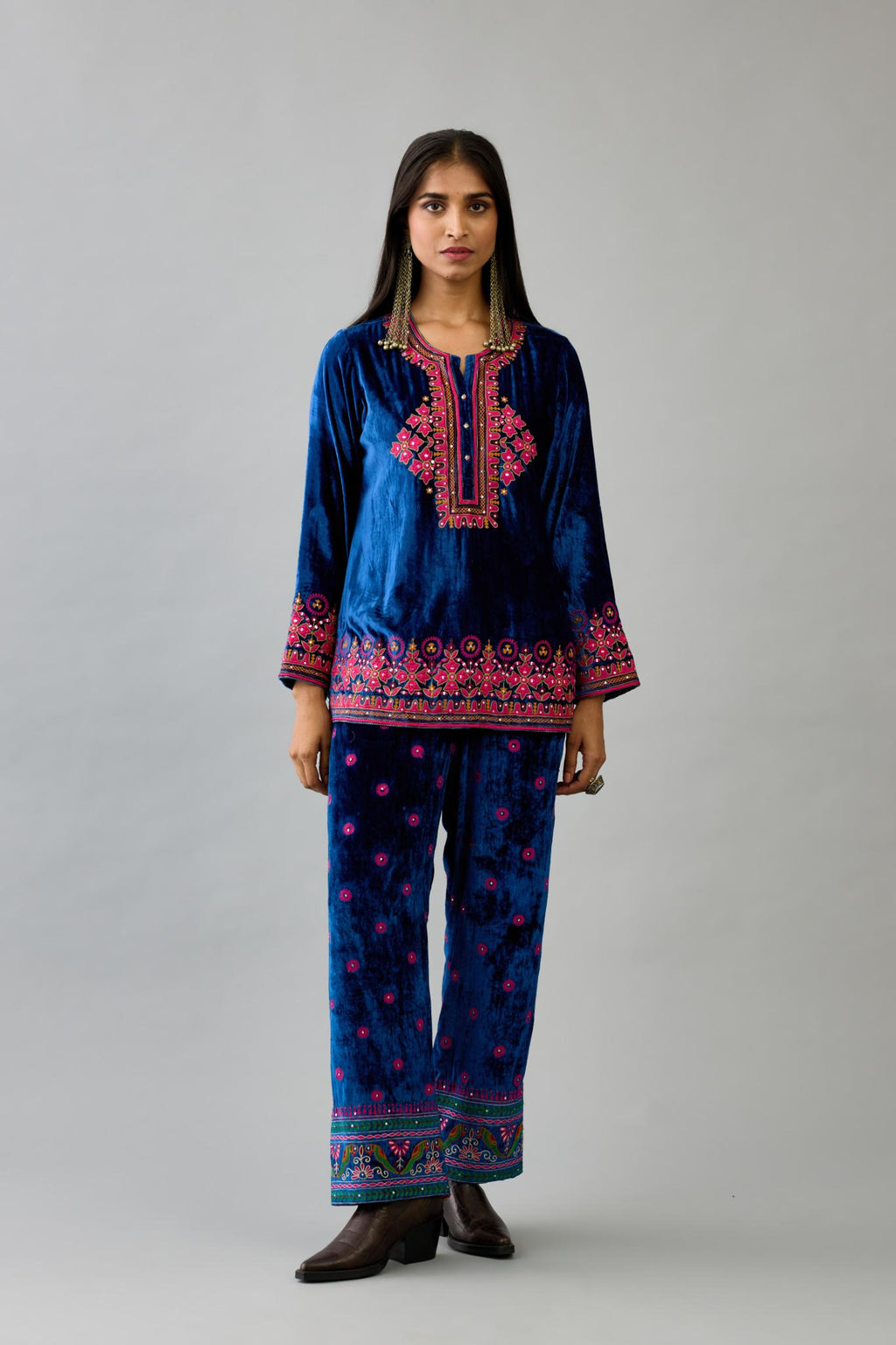 Blue silk velvet embroidered short top with 3/4th sleeves, paired with blue silk velvet straight pants with all over contrast color embroidery detailed with sequins.