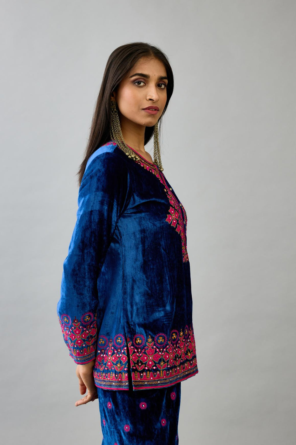 Blue silk velvet embroidered short top with 3/4th sleeves, paired with blue silk velvet straight pants with all over contrast color embroidery detailed with sequins.