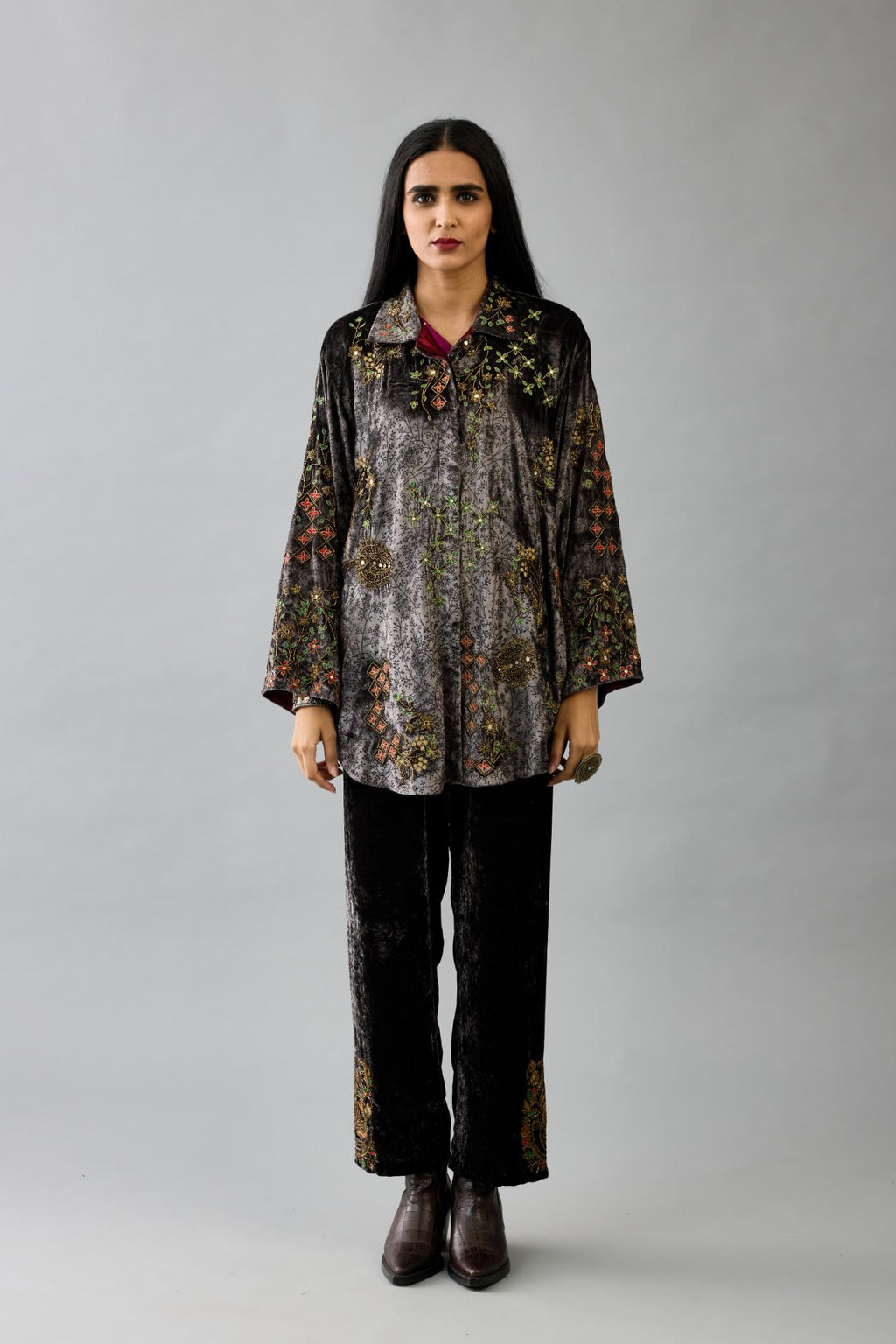 Grey silk velvet shirt with all-over hand block print, highlighted with sequins, beads and zari work, paired with grey silk velvet hand block printed straight pants with embroidered boota at sides, highlighted with sequins, beads and zari work.