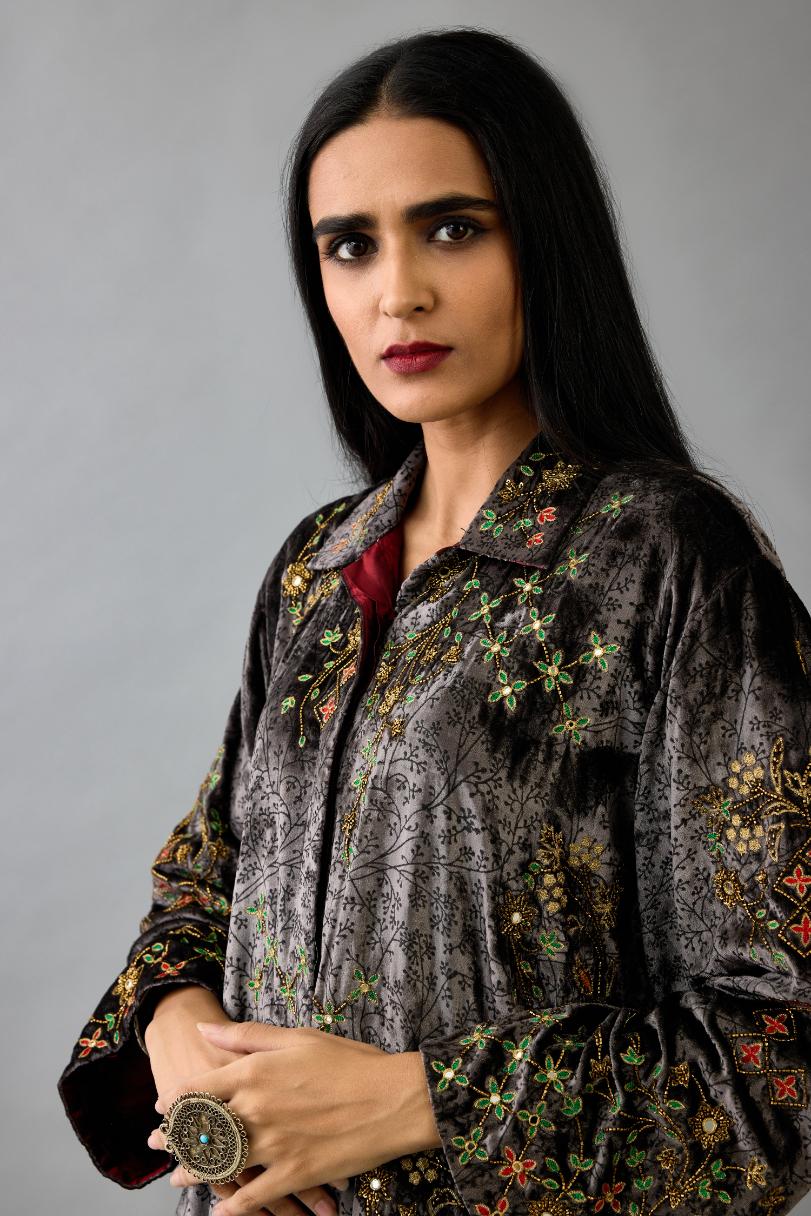 Grey silk velvet shirt with all-over hand block print, highlighted with sequins, beads and zari work, paired with grey silk velvet hand block printed straight pants with embroidered boota at sides, highlighted with sequins, beads and zari work.