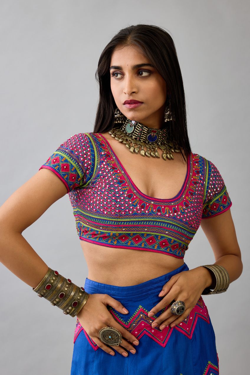 Blue silk embroidered choli set with deep round neck and princess seams.