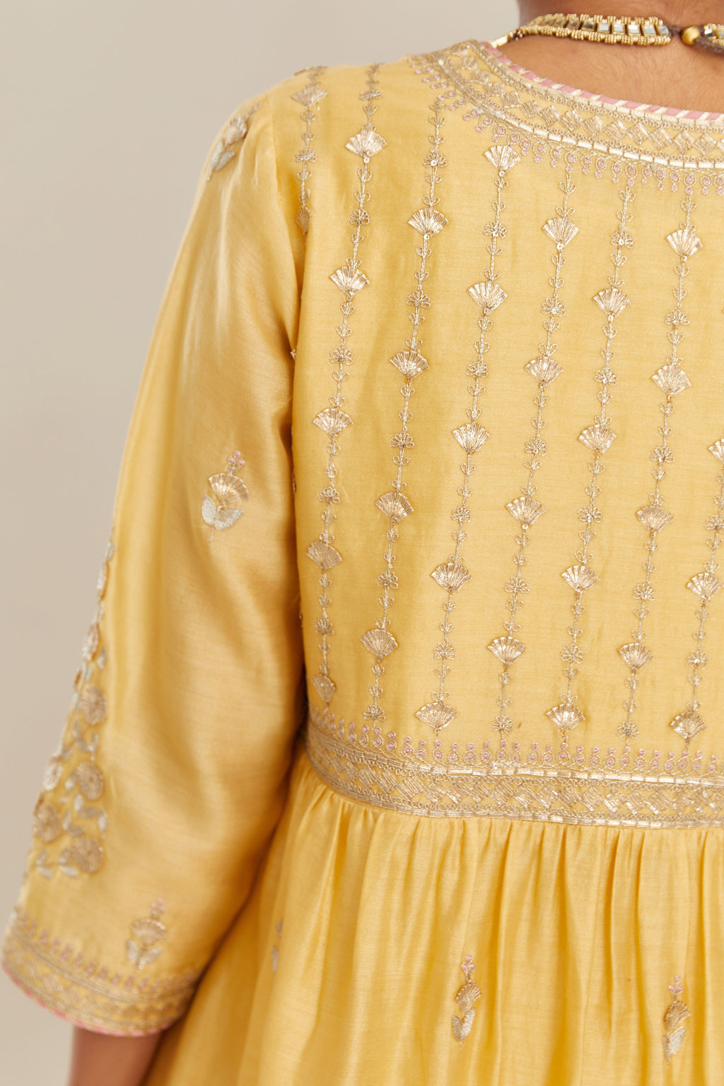 Yellow silk chanderi kurta set with heavy gold gota and zari embroidery and emroidered cotton slip inside.