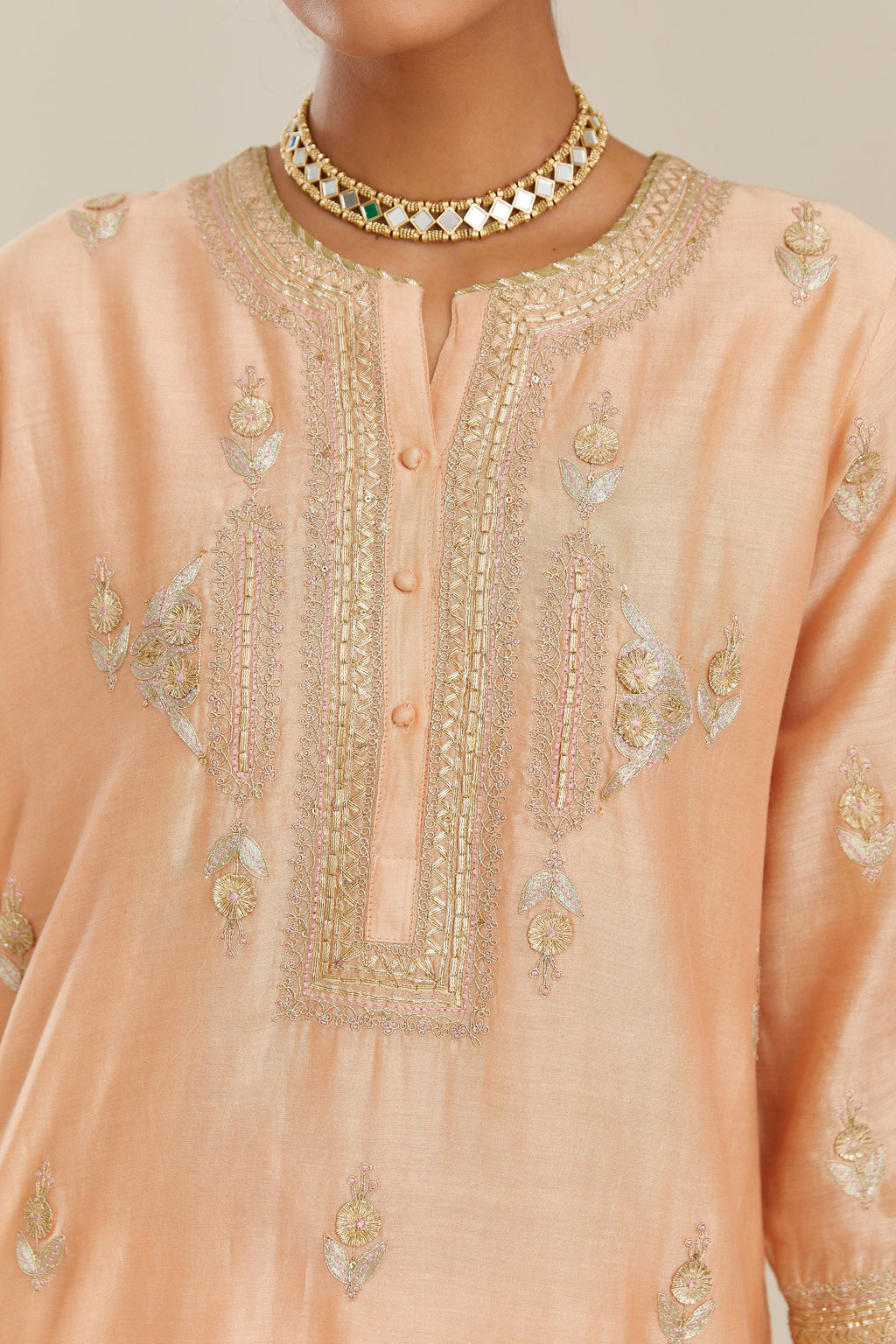 Peach silk chanderi straight kurta set with gold gota and zari embroidery.