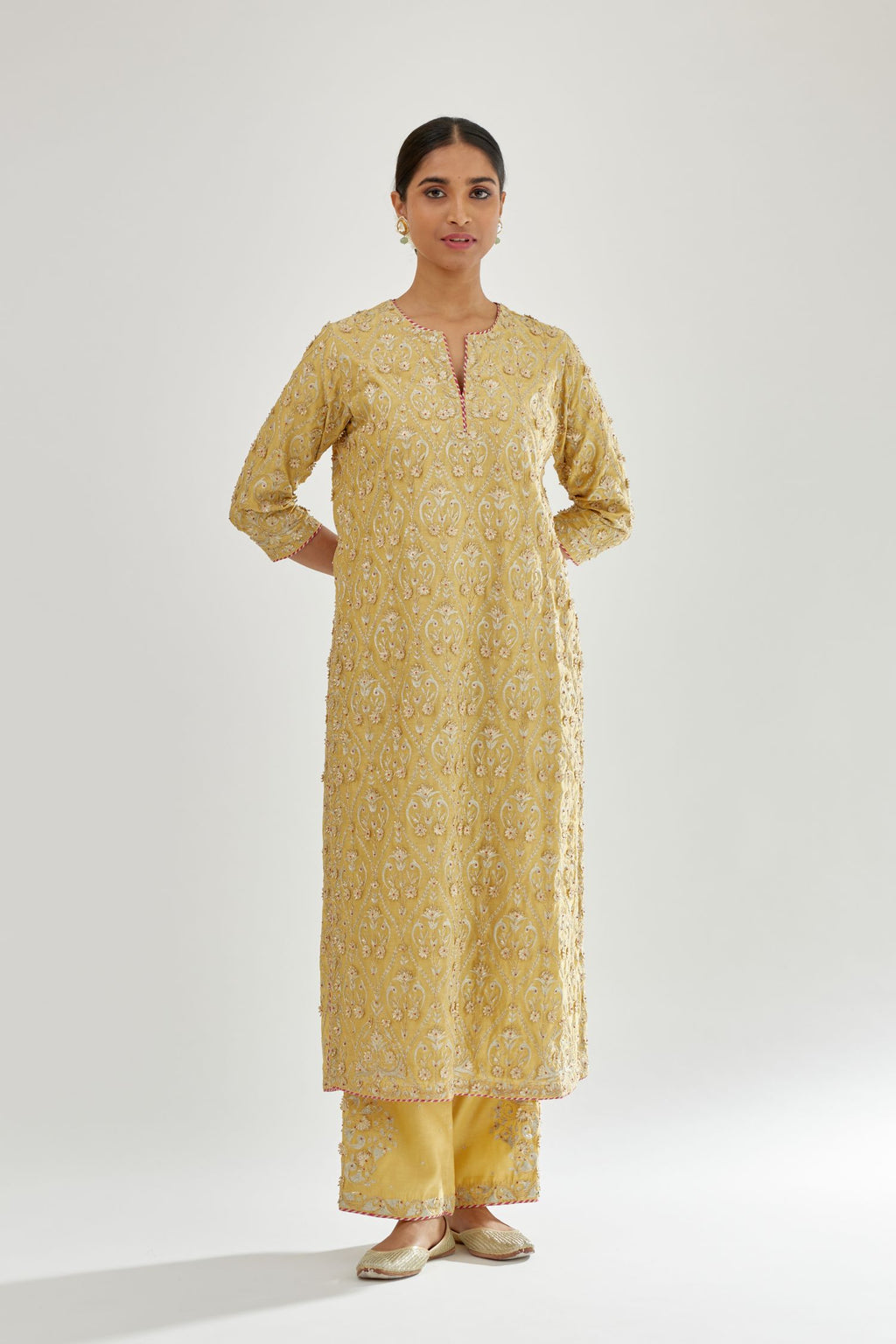 Yellow silk chanderi straight kurta set with all-over dori and gota jaal embroidery, highlighted with contrast bead work.