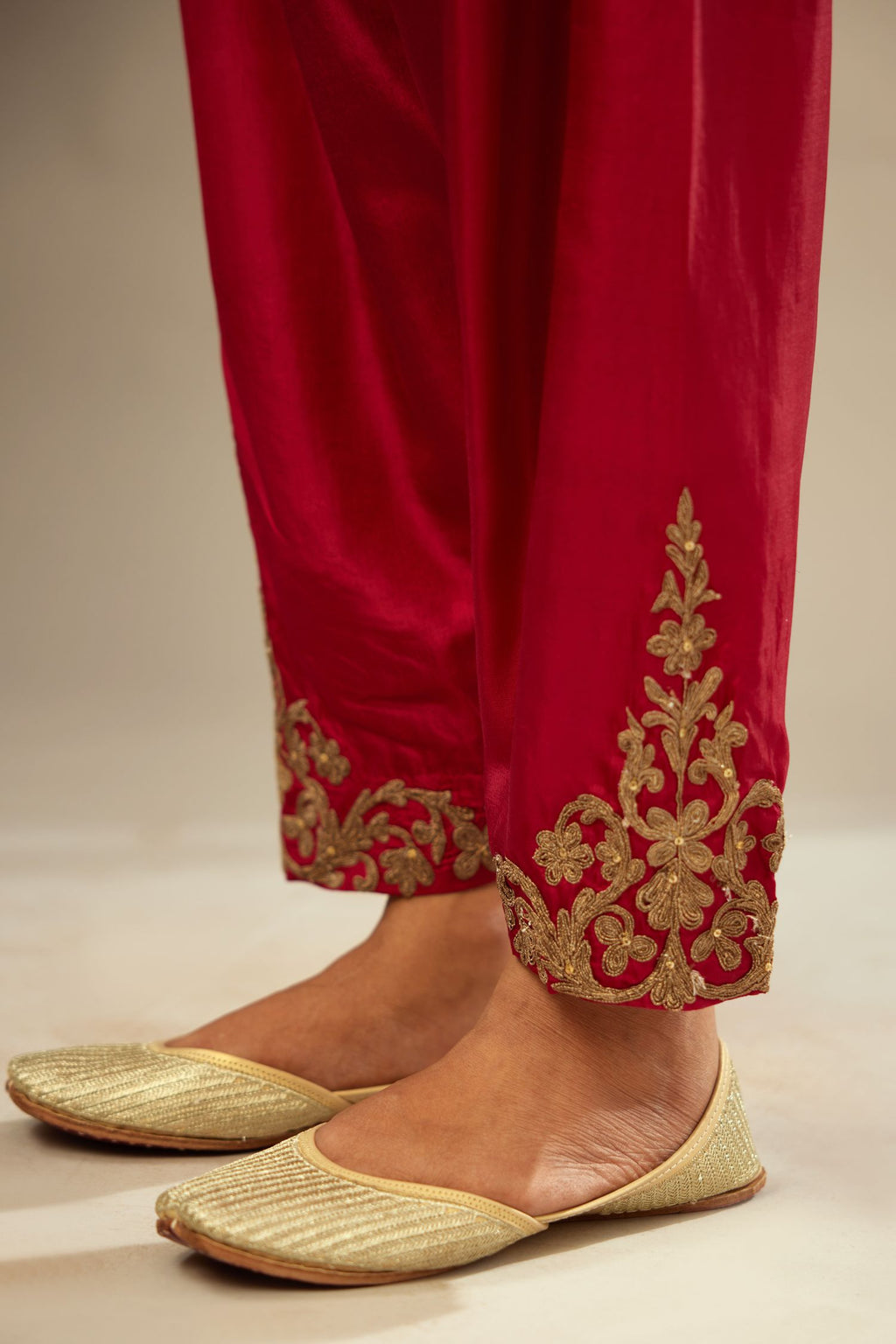 Fuchsia silk narrow salwar with light gold dori embroidery at hem.
