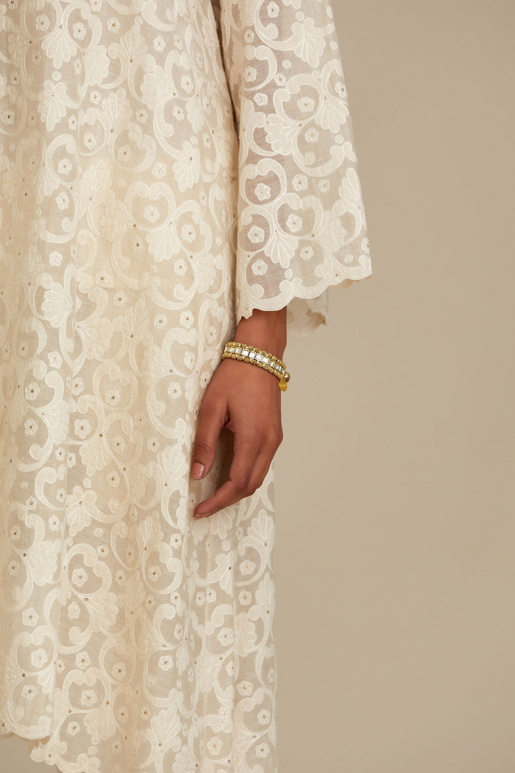 Off white short easy fit, straight hem kurta set with all-over trellis jaal appliqué, highlighted with sequins.