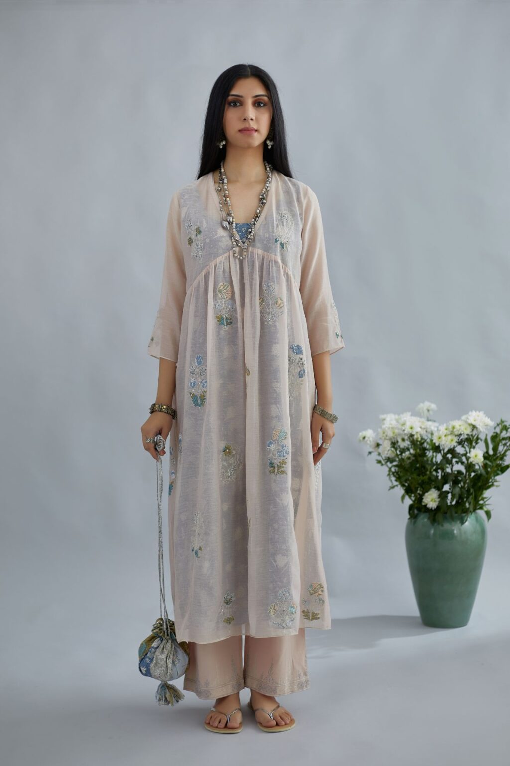 Cotton Chanderi kurta set with all-over assorted print floral applique, highlighted with sequin and silver zari embroidery.