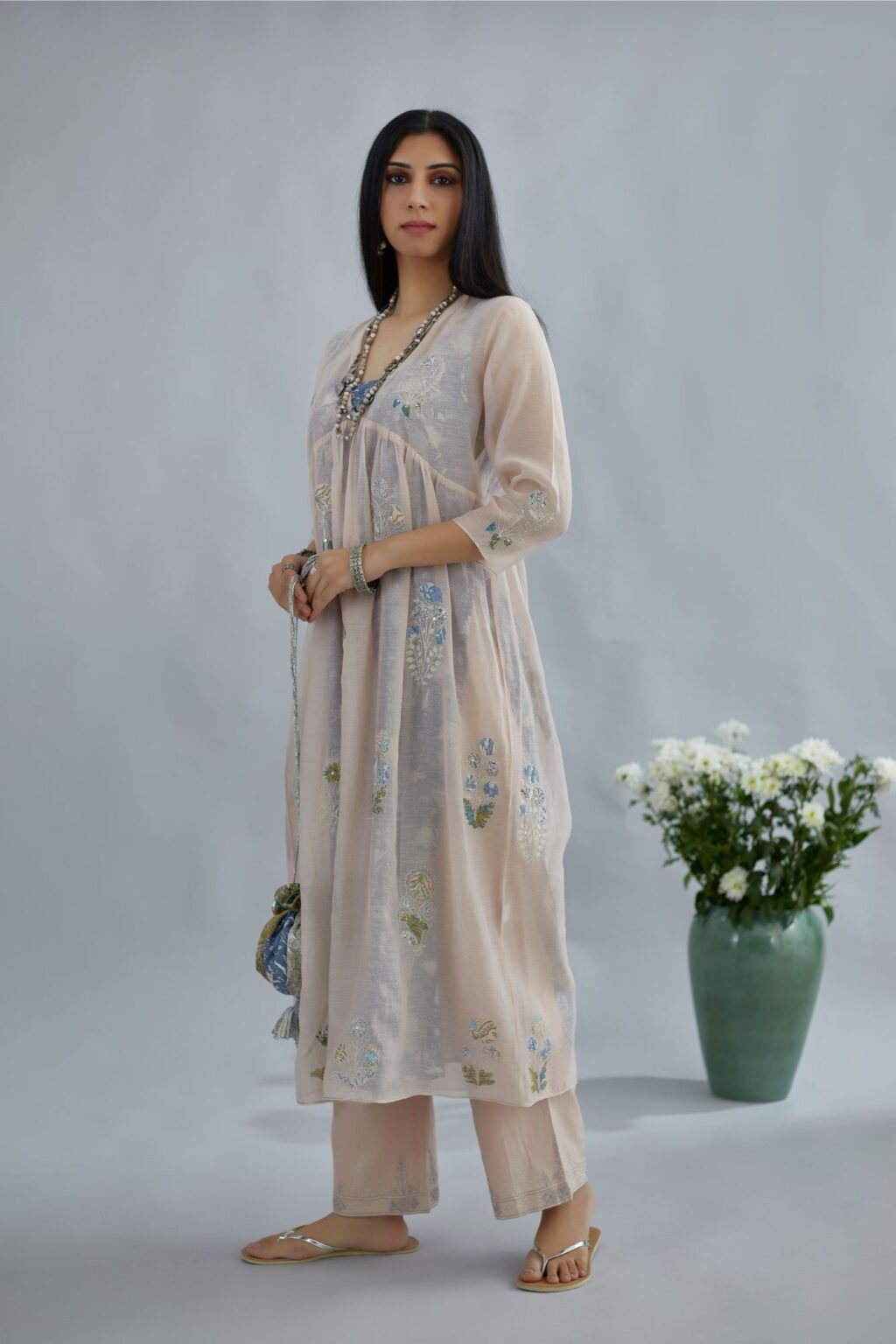 Cotton Chanderi kurta set with all-over assorted print floral applique, highlighted with sequin and silver zari embroidery.