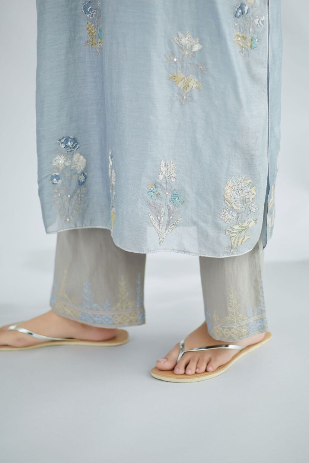 Pigeon blue silk Chanderi straight kurta set with all-over floral applique, highlighted with sequin embroidery and silver zari detail.