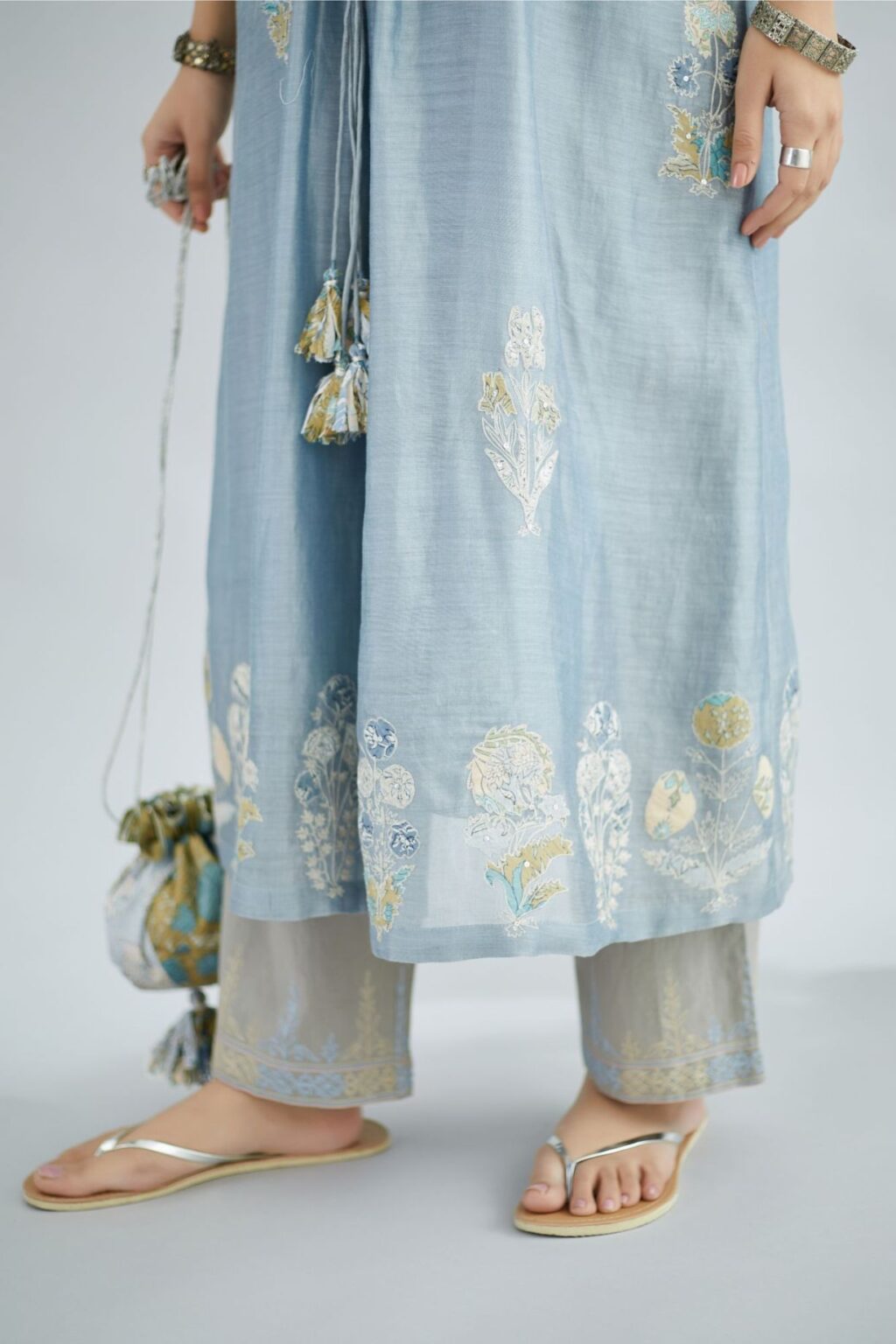 Silk Chanderi kurta set with all-over floral printed applique and fine gathers at waistline and ornamental cords at neckline