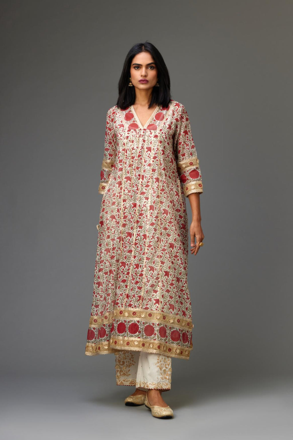 Red and off white hand block printed kurta dress with a V neck, detailed with gota at yoke and panels, paired with off-white cotton straight pants, hem is detailed with dori and gota embroidered boota at sides.