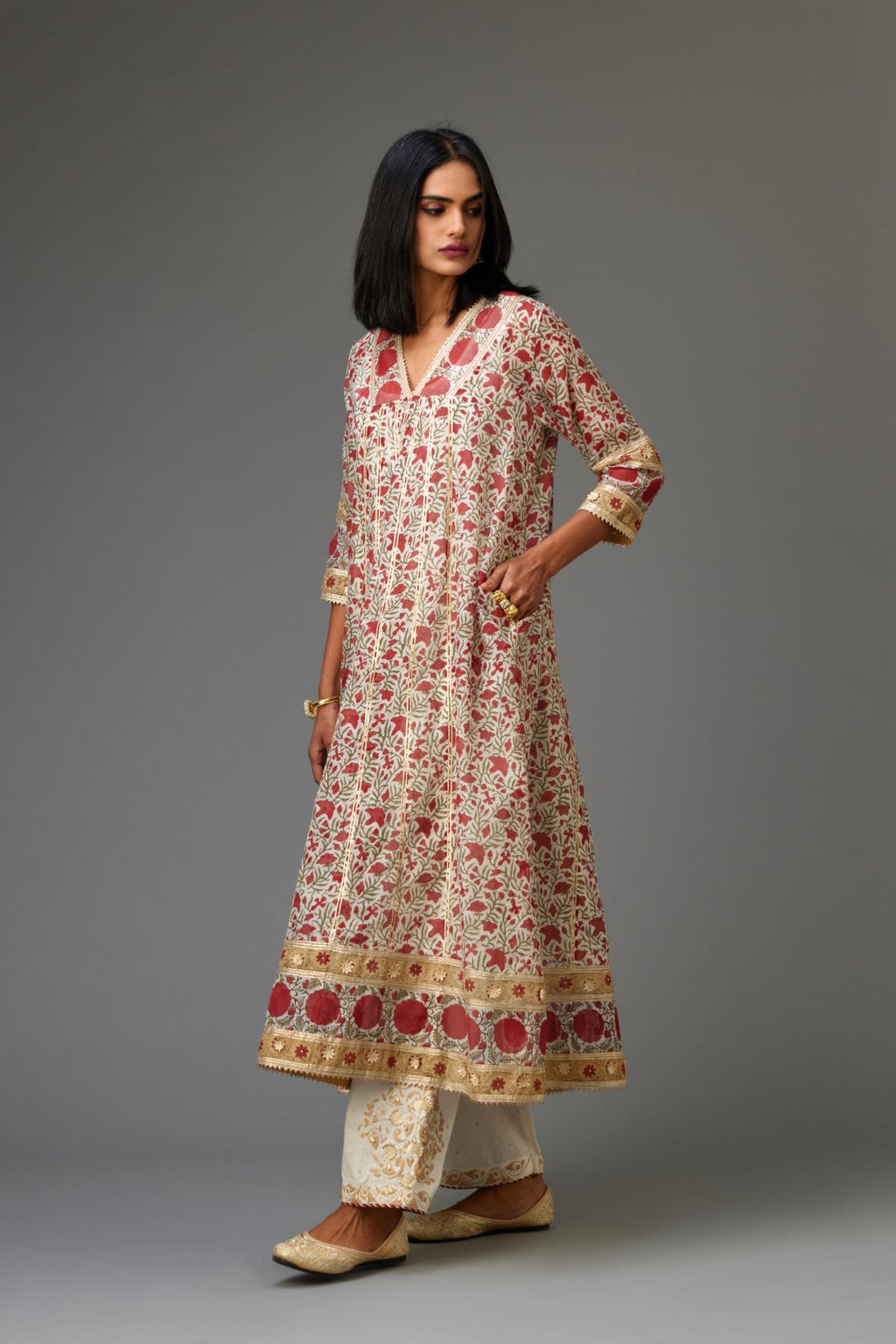 Red and off white hand block printed kurta dress with a V neck, detailed with gota at yoke and panels, paired with off-white cotton straight pants, hem is detailed with dori and gota embroidered boota at sides.