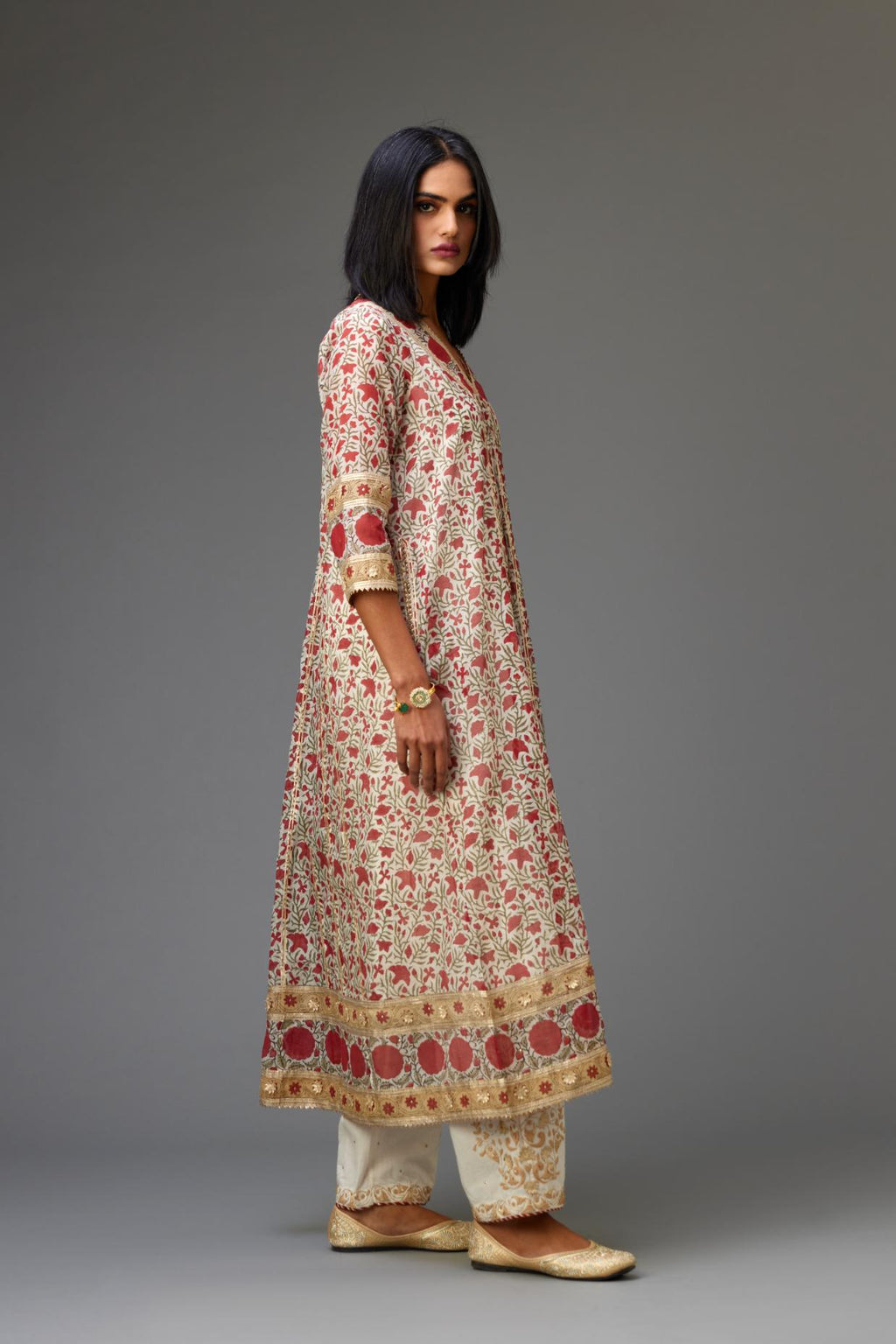 Red and off white hand block printed kurta dress with a V neck, detailed with gota at yoke and panels, paired with off-white cotton straight pants, hem is detailed with dori and gota embroidered boota at sides.