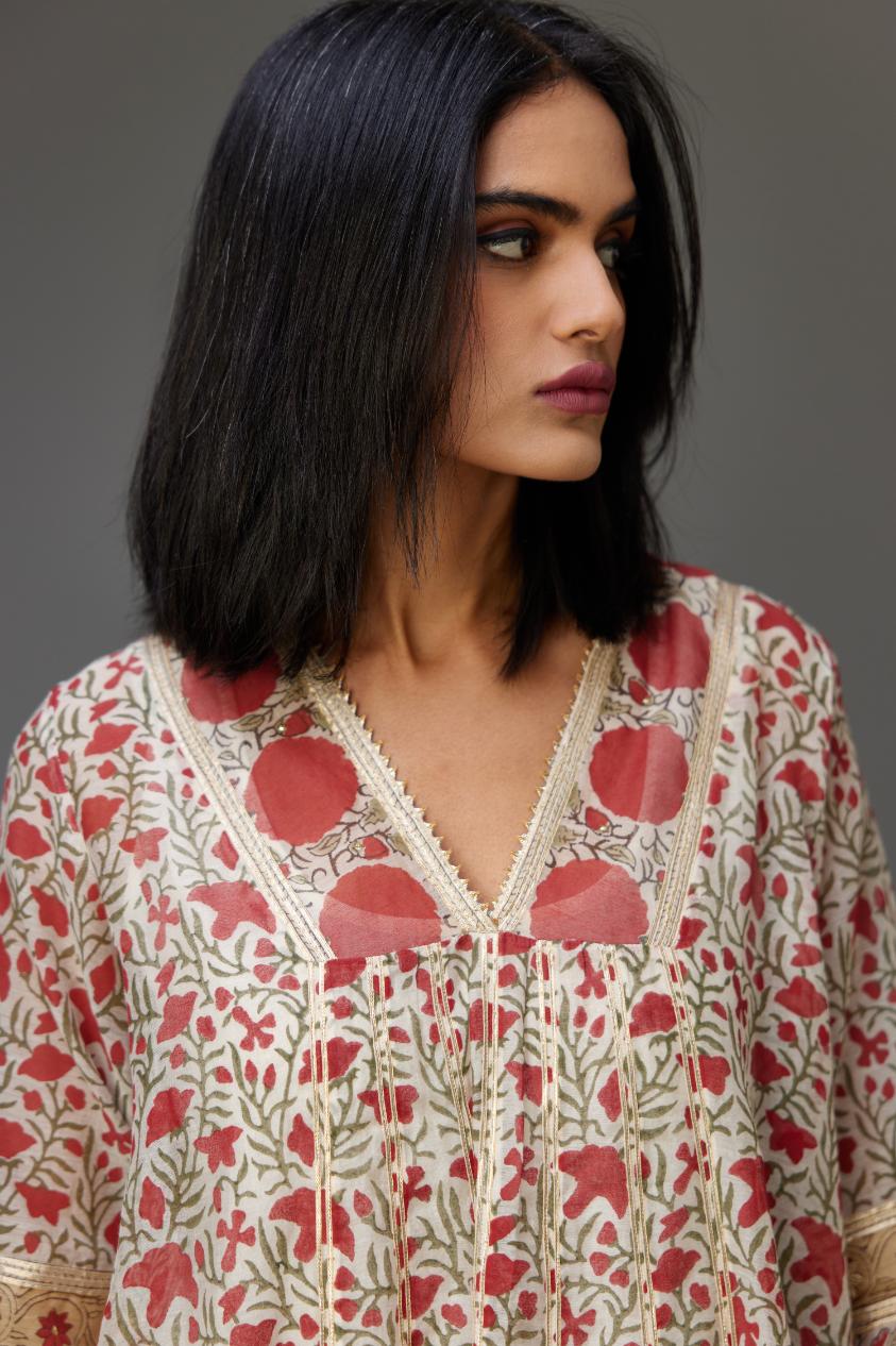 Red and off white hand block printed kurta dress with a V neck, detailed with gota at yoke and panels, paired with off-white cotton straight pants, hem is detailed with dori and gota embroidered boota at sides.