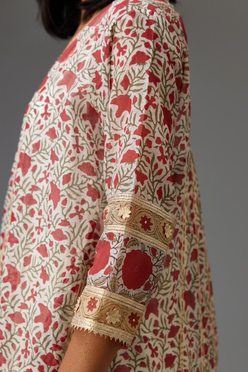 Red and off white hand block printed kurta dress with a V neck, detailed with gota at yoke and panels, paired with off-white cotton straight pants, hem is detailed with dori and gota embroidered boota at sides.