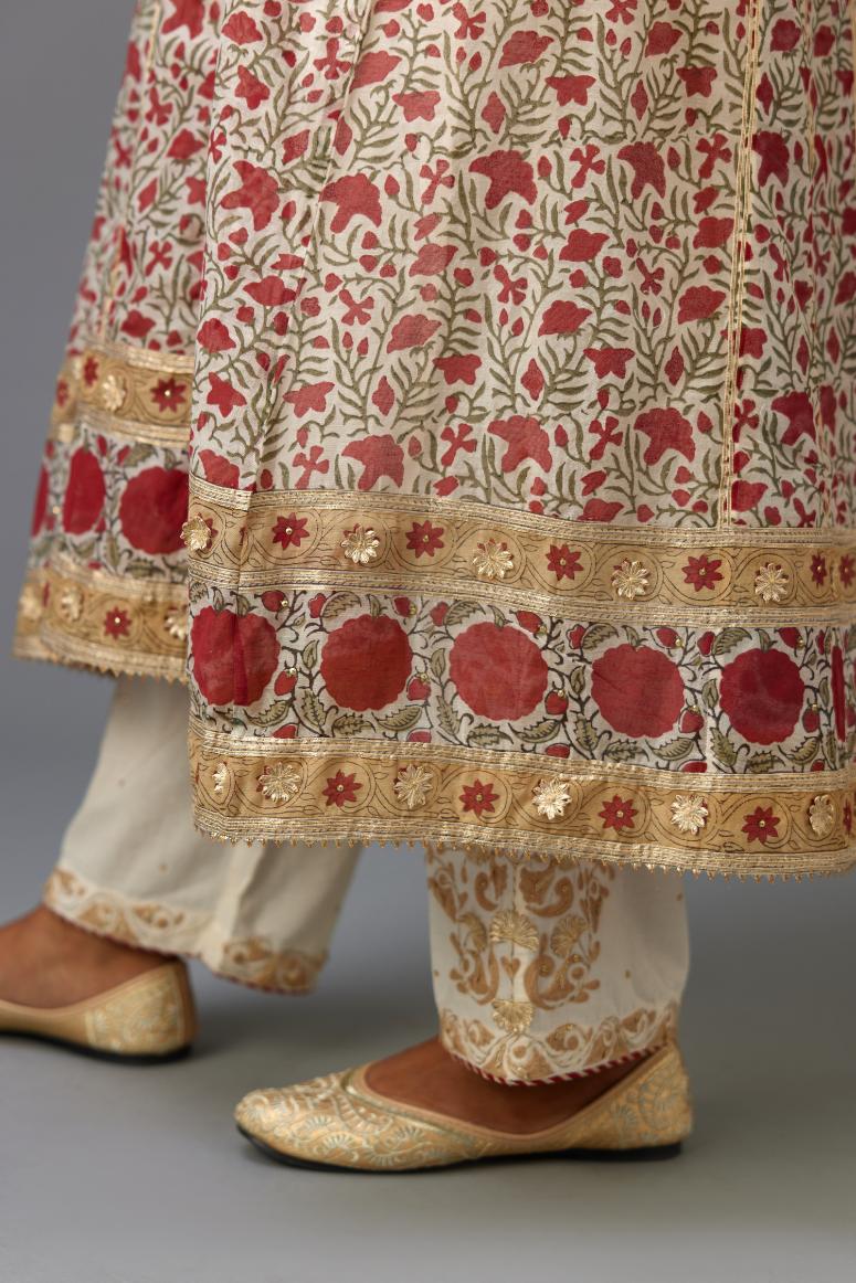 Red and off white hand block printed kurta dress with a V neck, detailed with gota at yoke and panels, paired with off-white cotton straight pants, hem is detailed with dori and gota embroidered boota at sides.