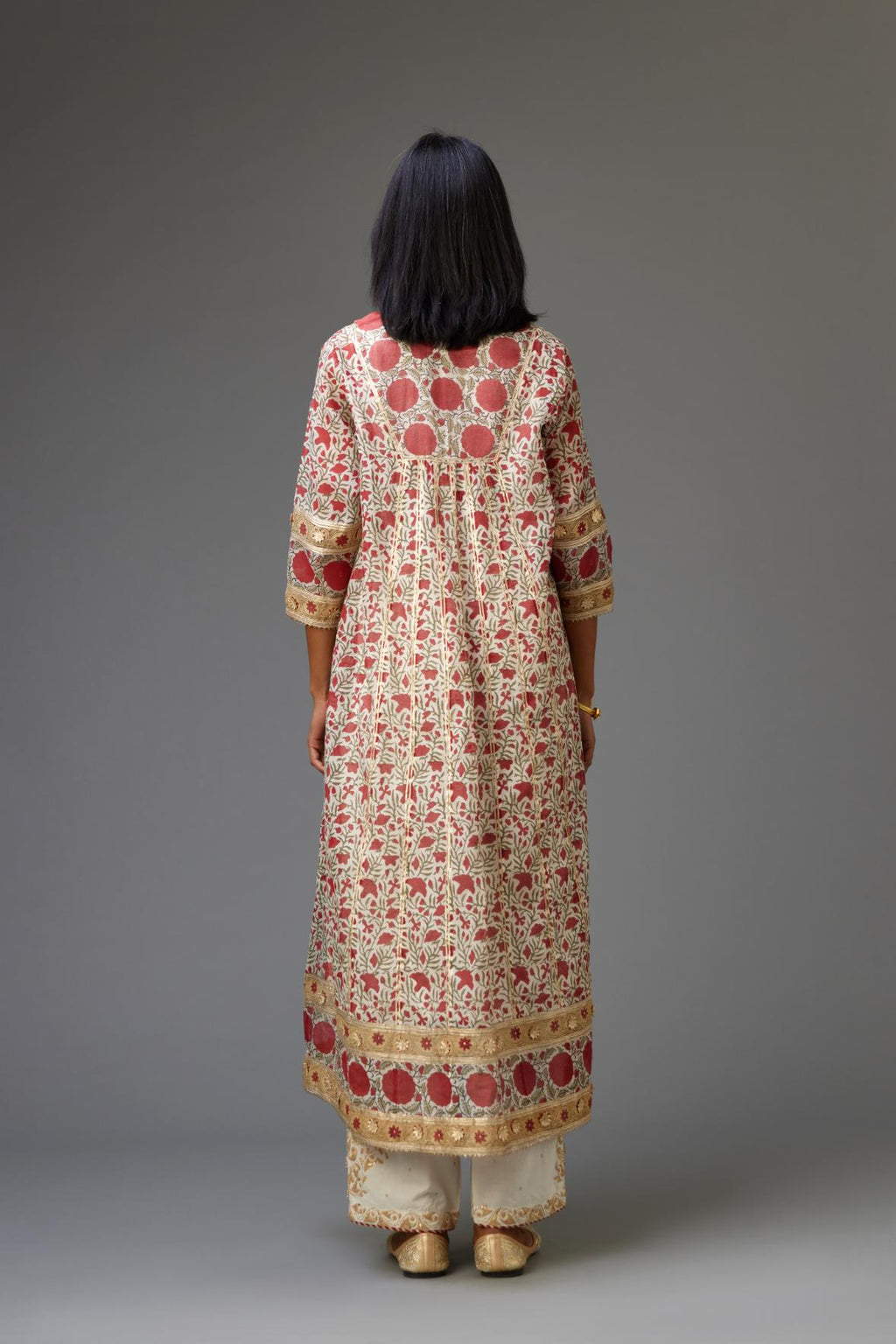 Red and off white hand block printed kurta dress with a V neck, detailed with gota at yoke and panels, paired with off-white cotton straight pants, hem is detailed with dori and gota embroidered boota at sides.