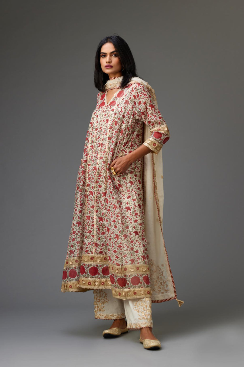 Red and off white hand block printed kurta dress with a V neck, detailed with gota at yoke and panels, paired with off-white cotton straight pants, hem is detailed with dori and gota embroidered boota at sides.