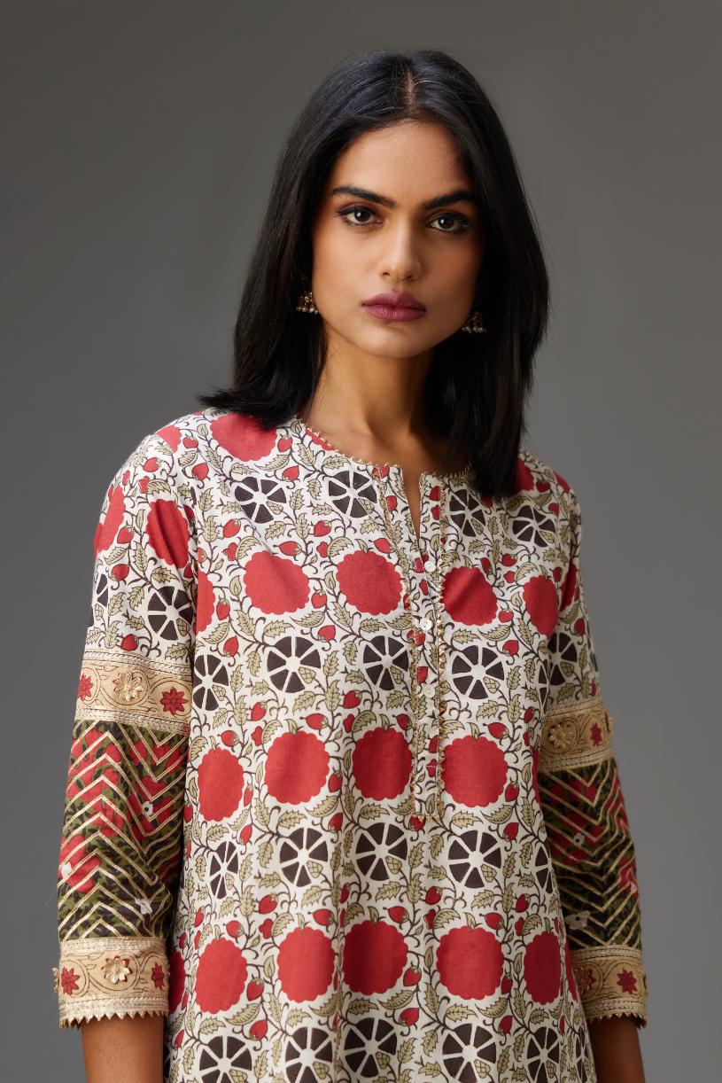 Hand block printed A-line cotton straight kurta with gota detailing, paired with red and green cotton hand block printed straight pants detailed with gota at the border.