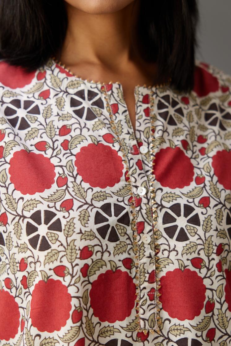 Hand block printed A-line cotton straight kurta with gota detailing, paired with red and green cotton hand block printed straight pants detailed with gota at the border.