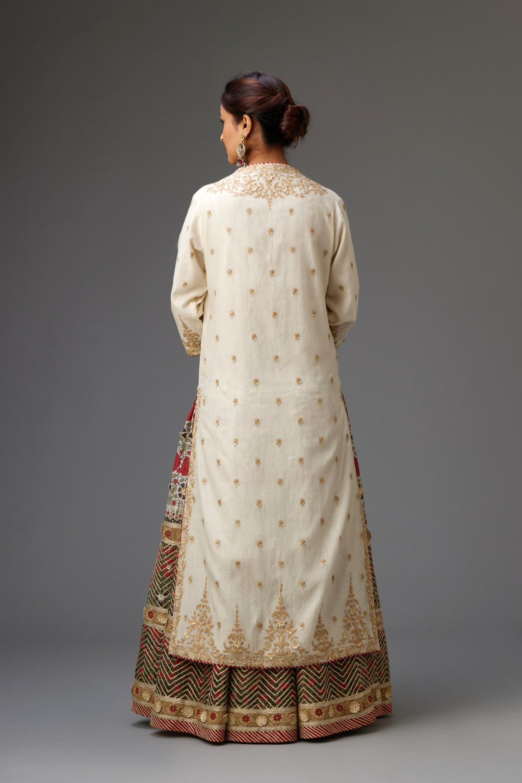 Off white cotton chanderi straight kurta with dori and gota embroidery, detailed with all-over delicate aari embroidery buties, paired with Silk chanderi hand block printed lehenga with herringbone gota embroidery at hem.