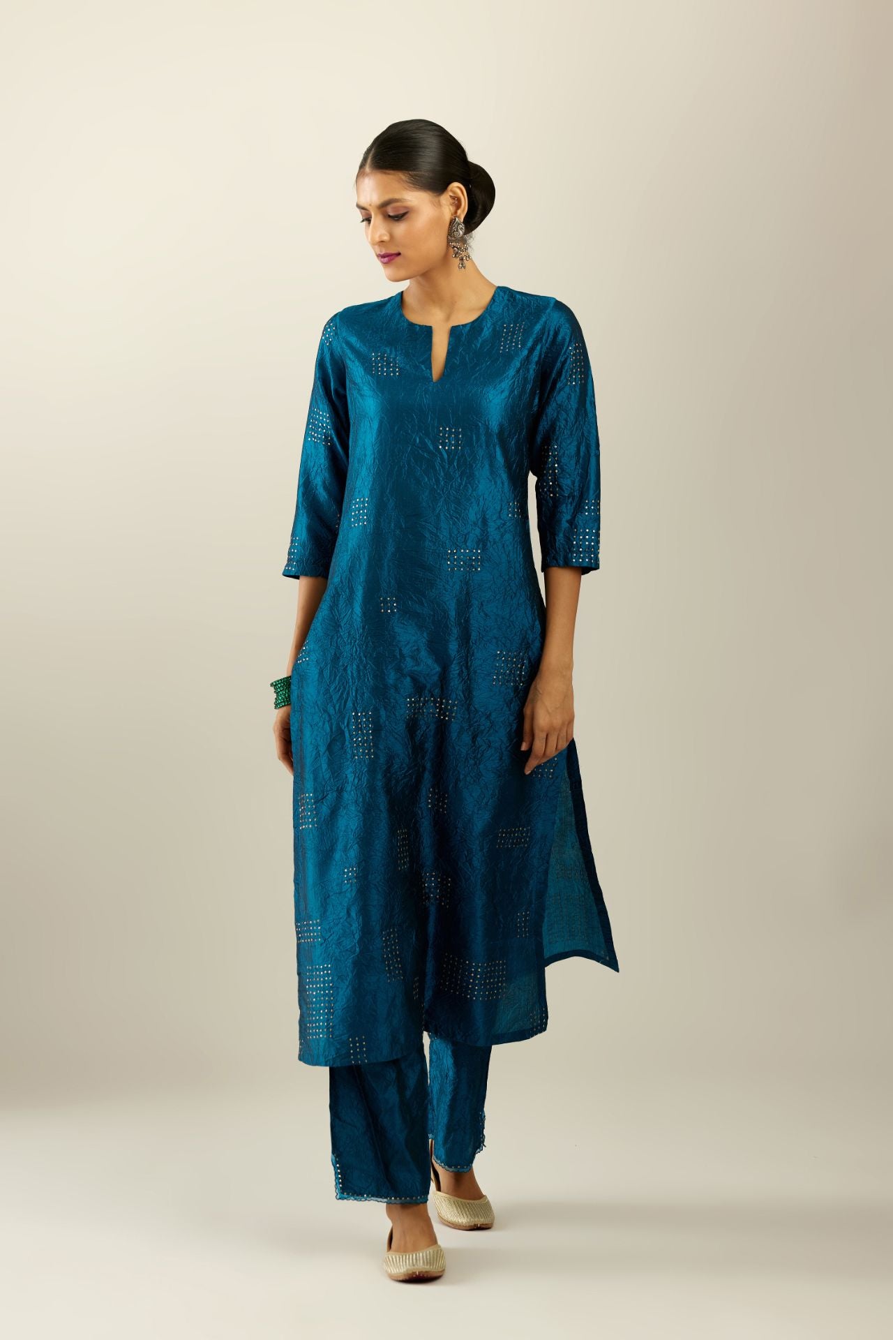 Dark teal hand crushed silk straight kurta, highlighted with all-over gold sequins rectangles, paired with  dark teal hand crushed silk straight pants with scalloped and embroidered organza at edges and detailed with a single line of sequins at hem