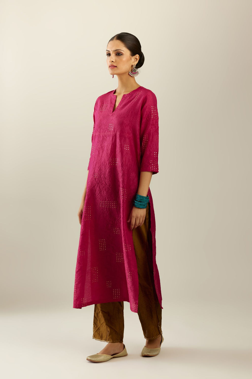Jazzberry jam hand crushed silk straight kurta, highlighted with all-over gold sequins rectangles, paired with  golden olive hand crushed silk straight pants with scalloped and embroidered organza at edges.