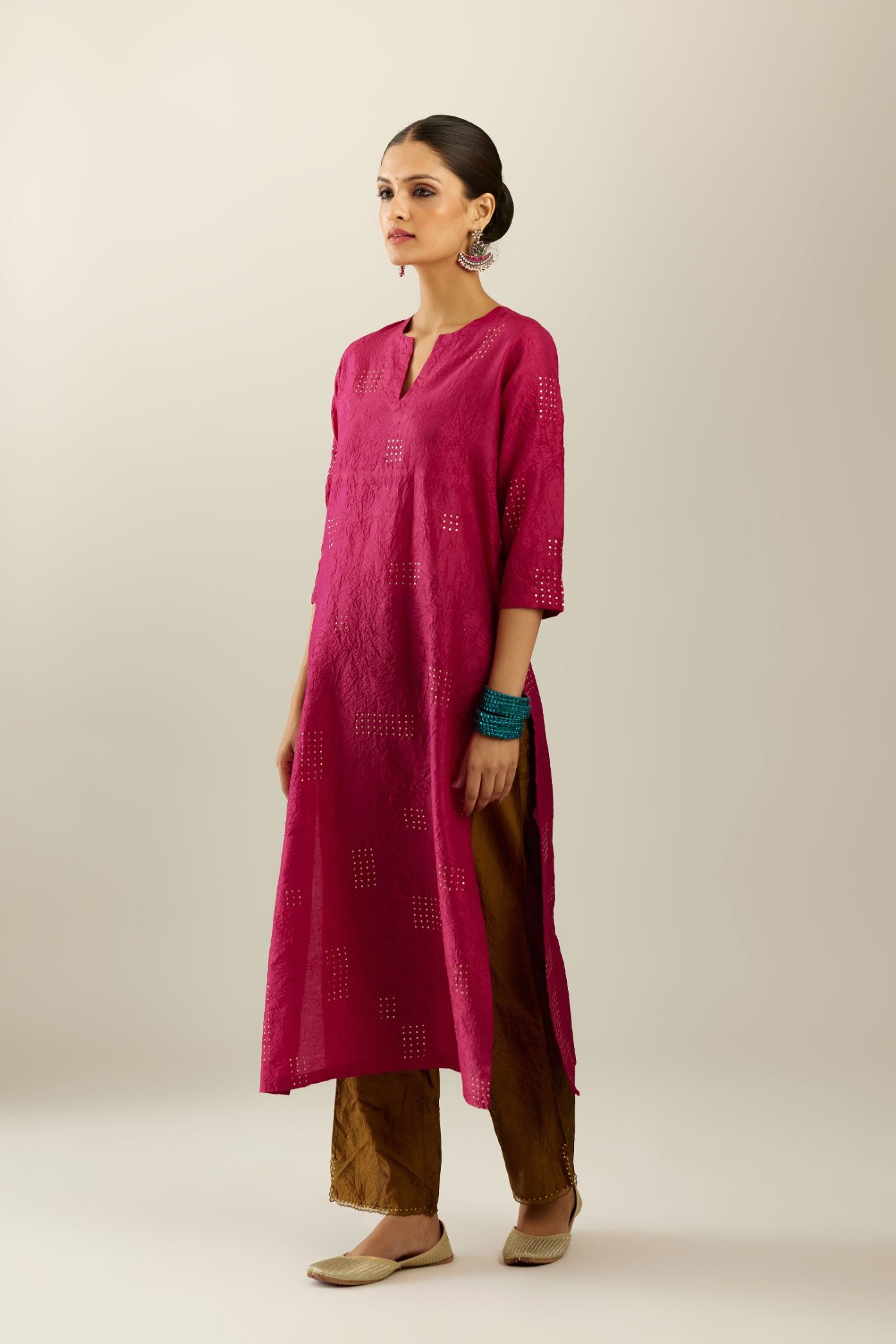 Jazzberry jam hand crushed silk straight kurta, highlighted with all-over gold sequins rectangles, paired with  golden olive hand crushed silk straight pants with scalloped and embroidered organza at edges.