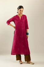 Jazzberry jam hand crushed silk straight kurta, highlighted with all-over gold sequins rectangles, paired with  golden olive hand crushed silk straight pants with scalloped and embroidered organza at edges.