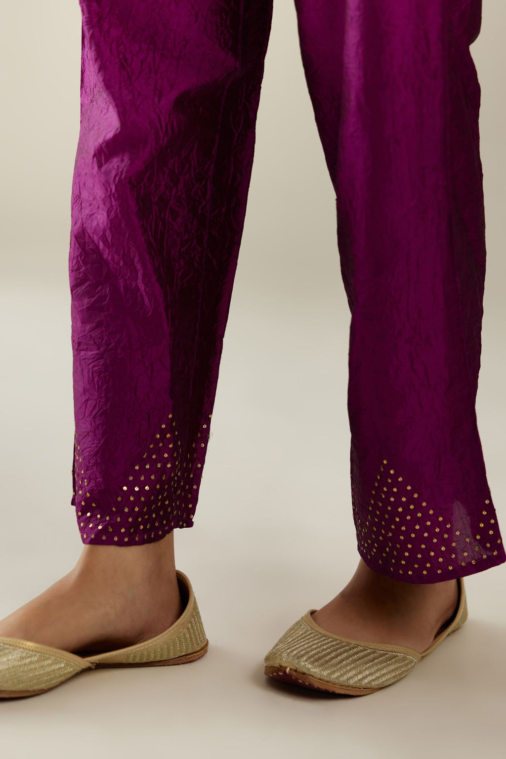 Sangria hand crushed pure silk straight pants with gold sequins work at hem and side pockets.